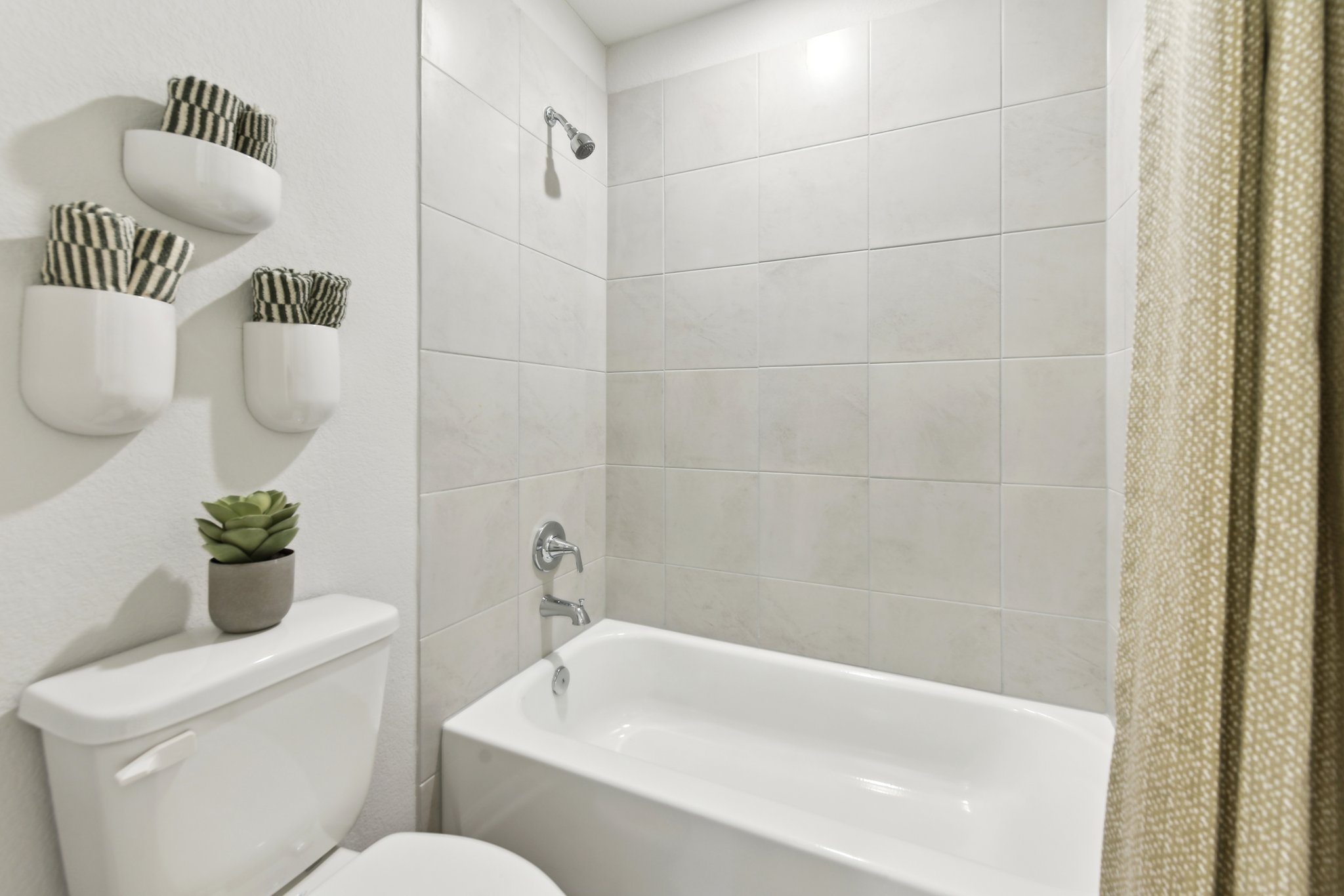 A bathroom with a tub toilet and sink.