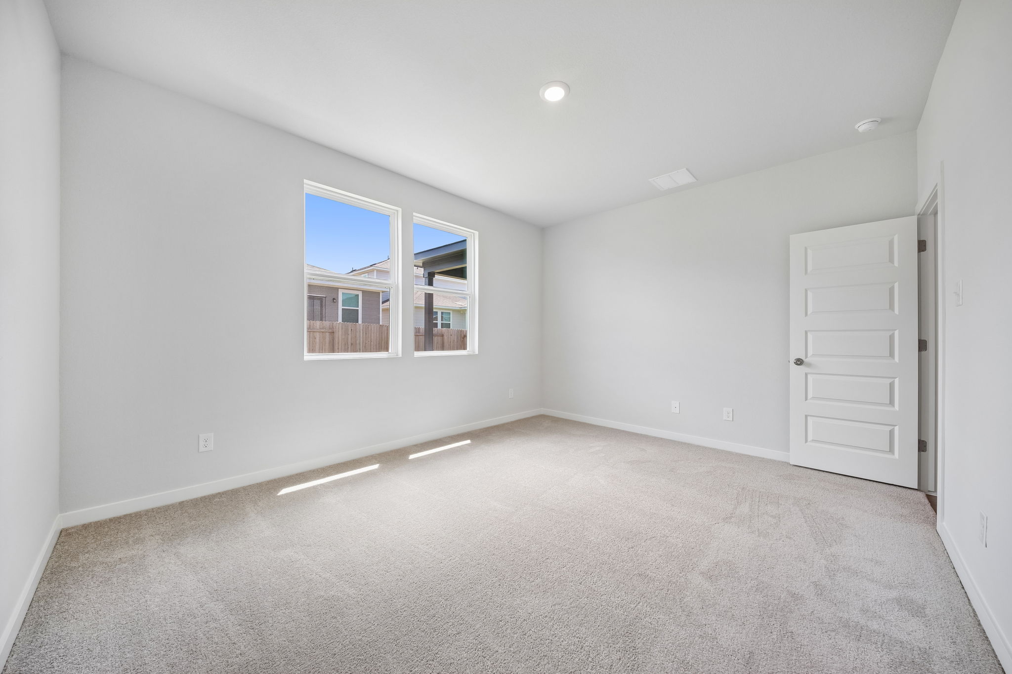 A room with a window and a door.