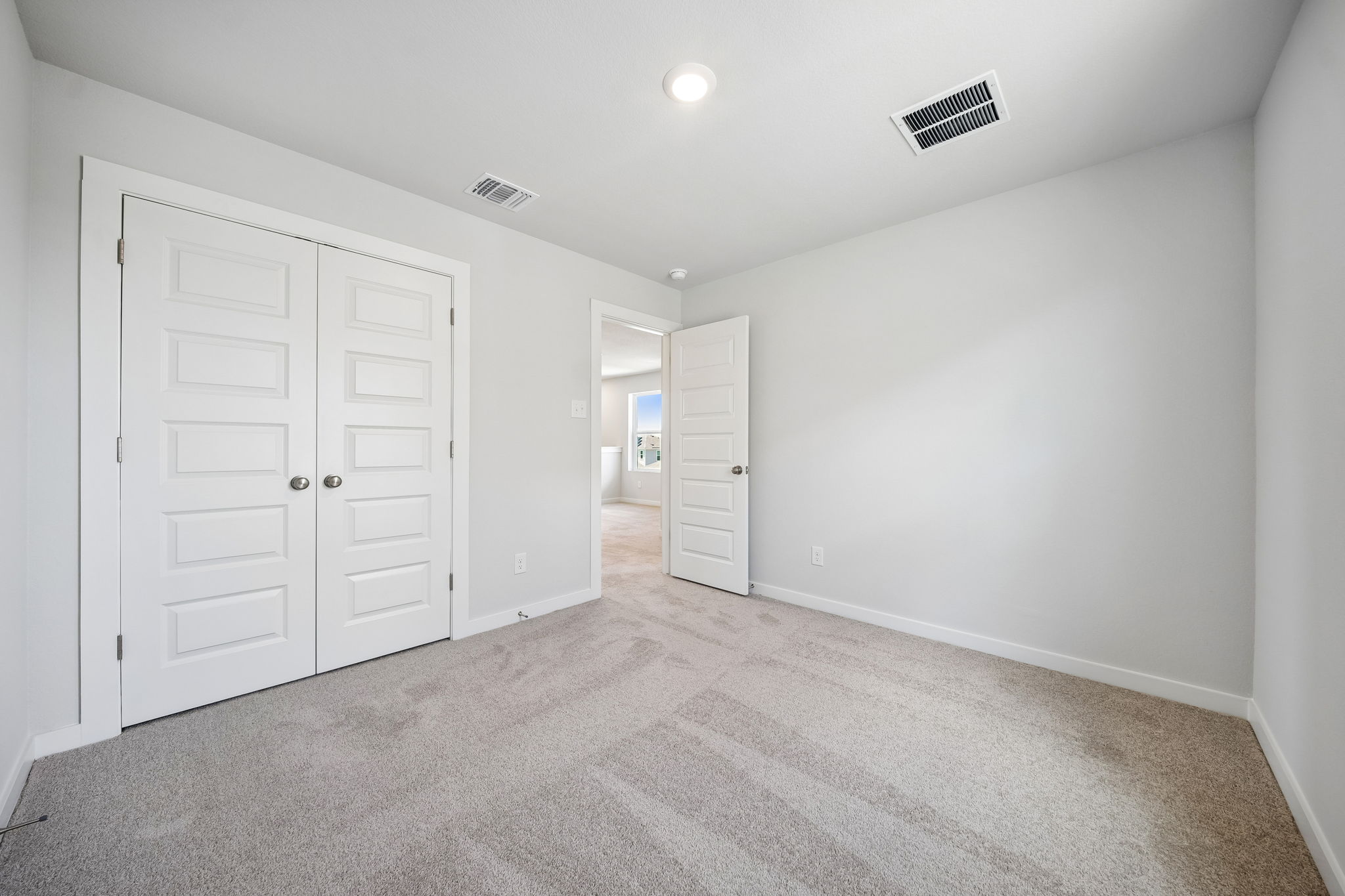 A hallway with white doors.