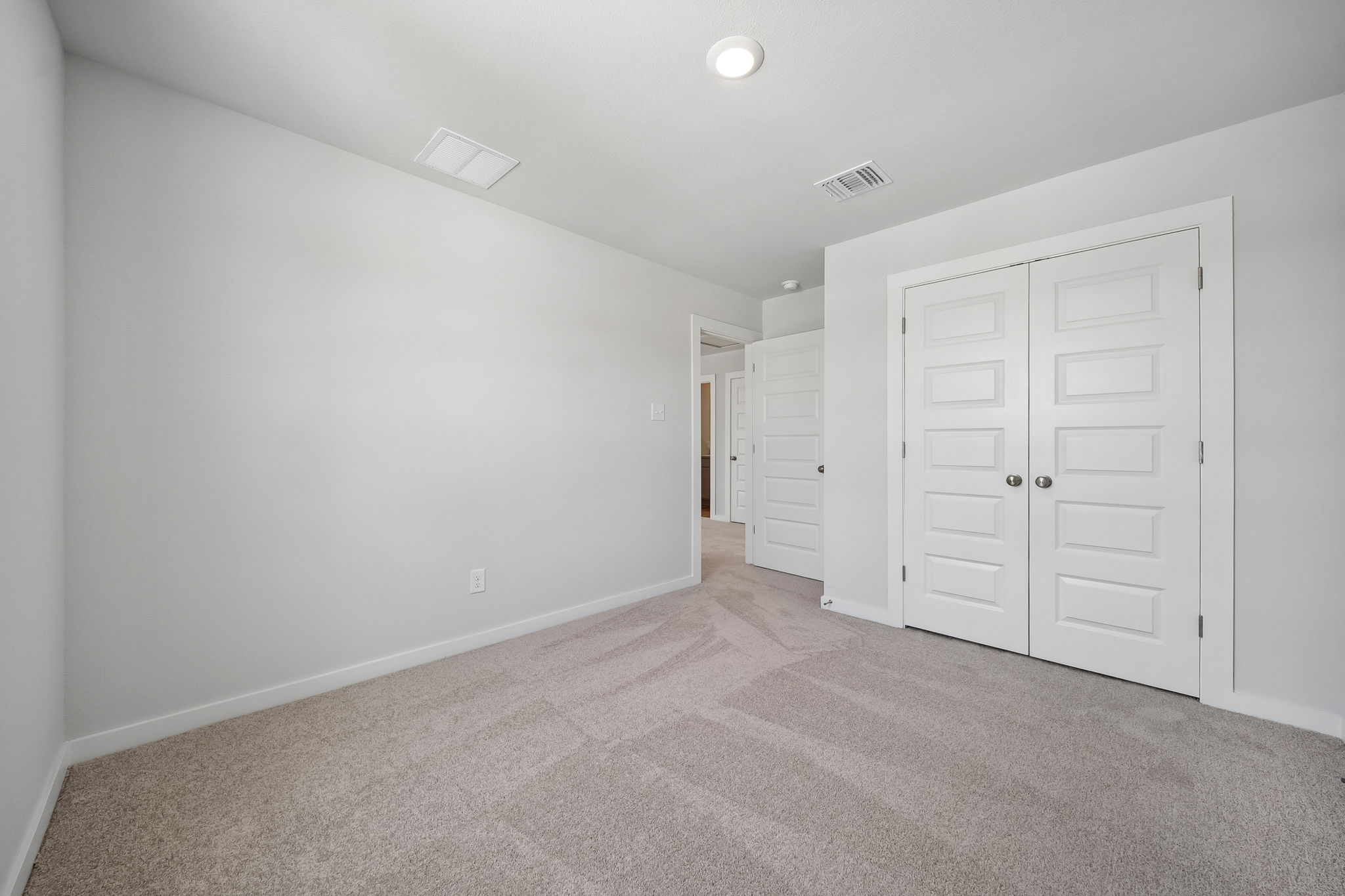 A hallway with white doors.
