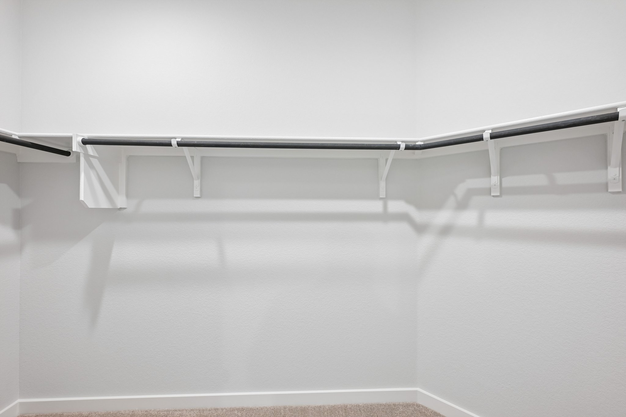 A metal bar on a white surface.