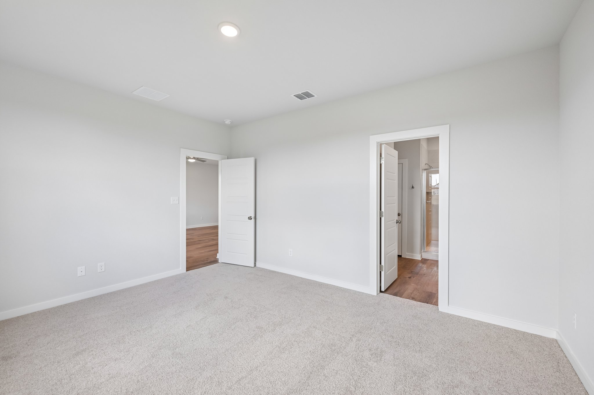 A hallway with white walls.