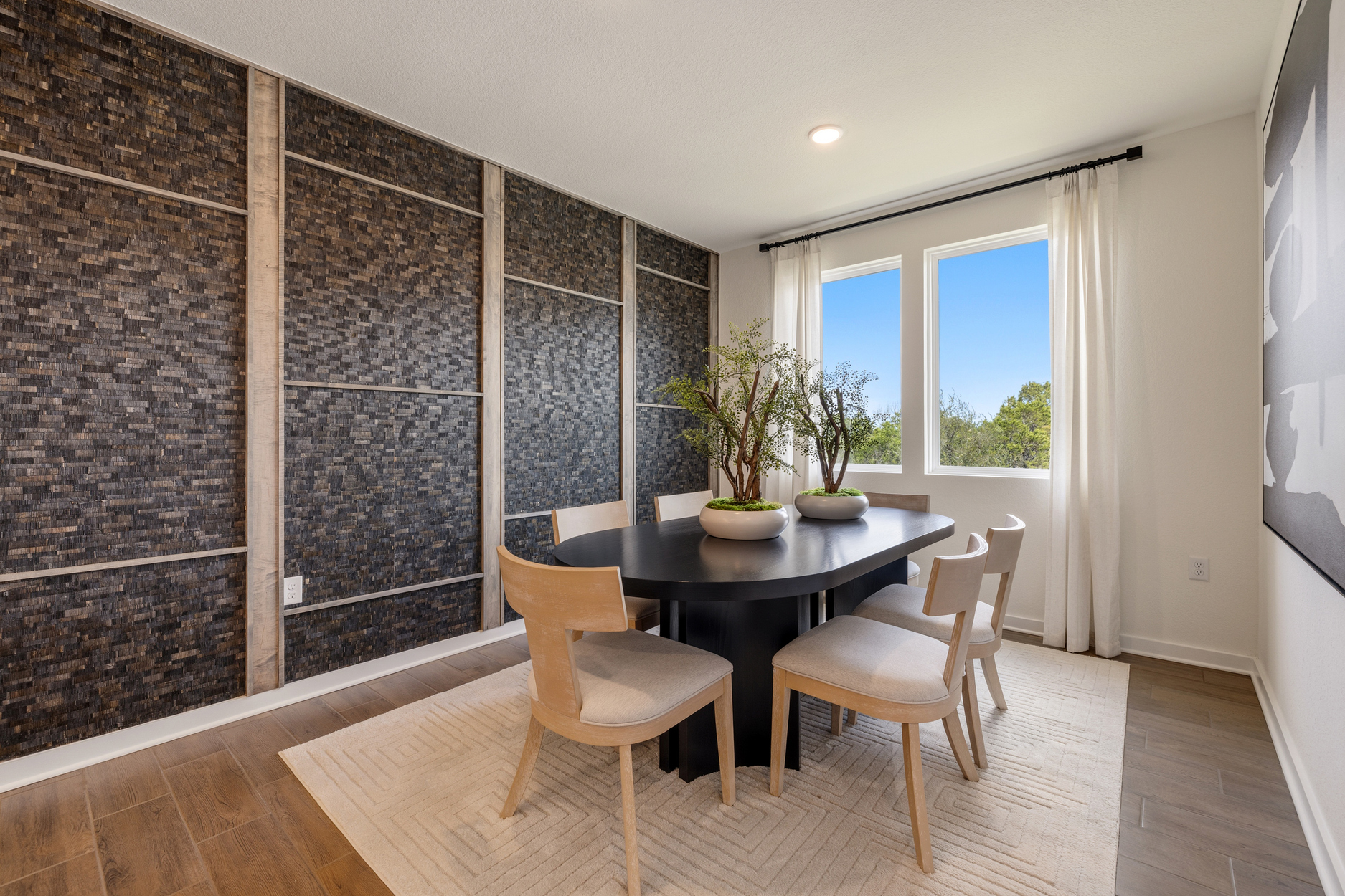 A room with a table chairs and a window.