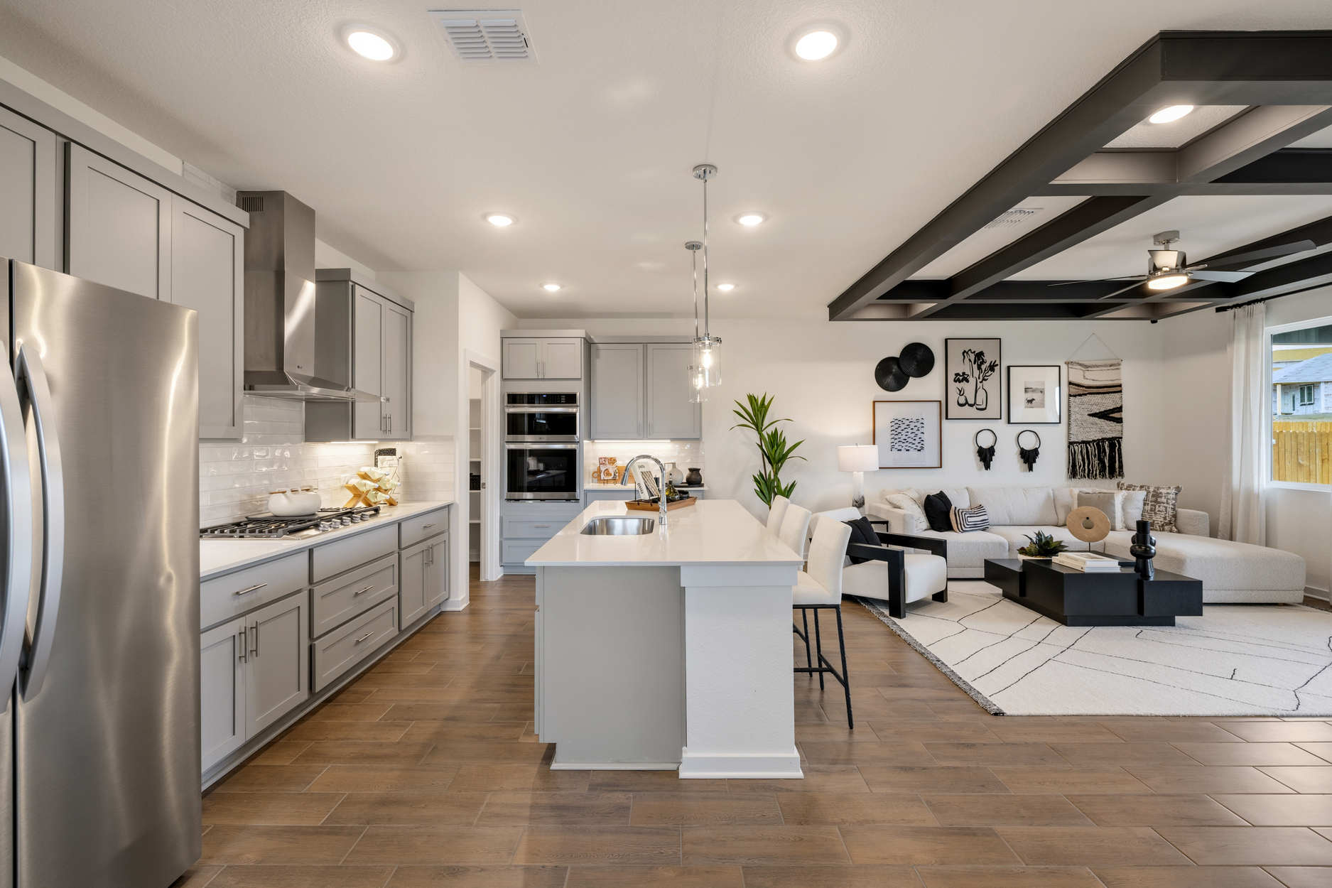 A kitchen with white cabinets.