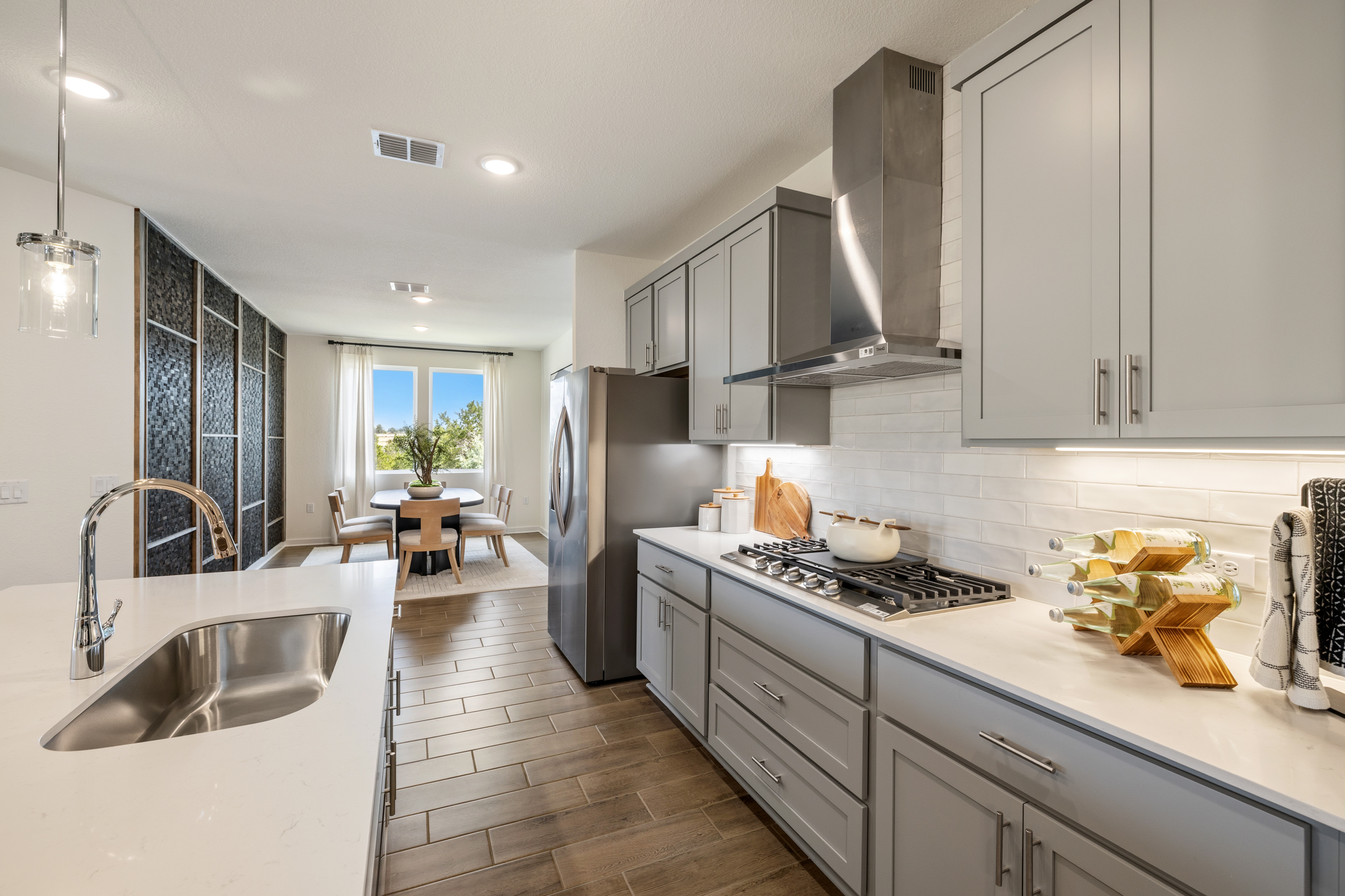A kitchen with white cabinets.