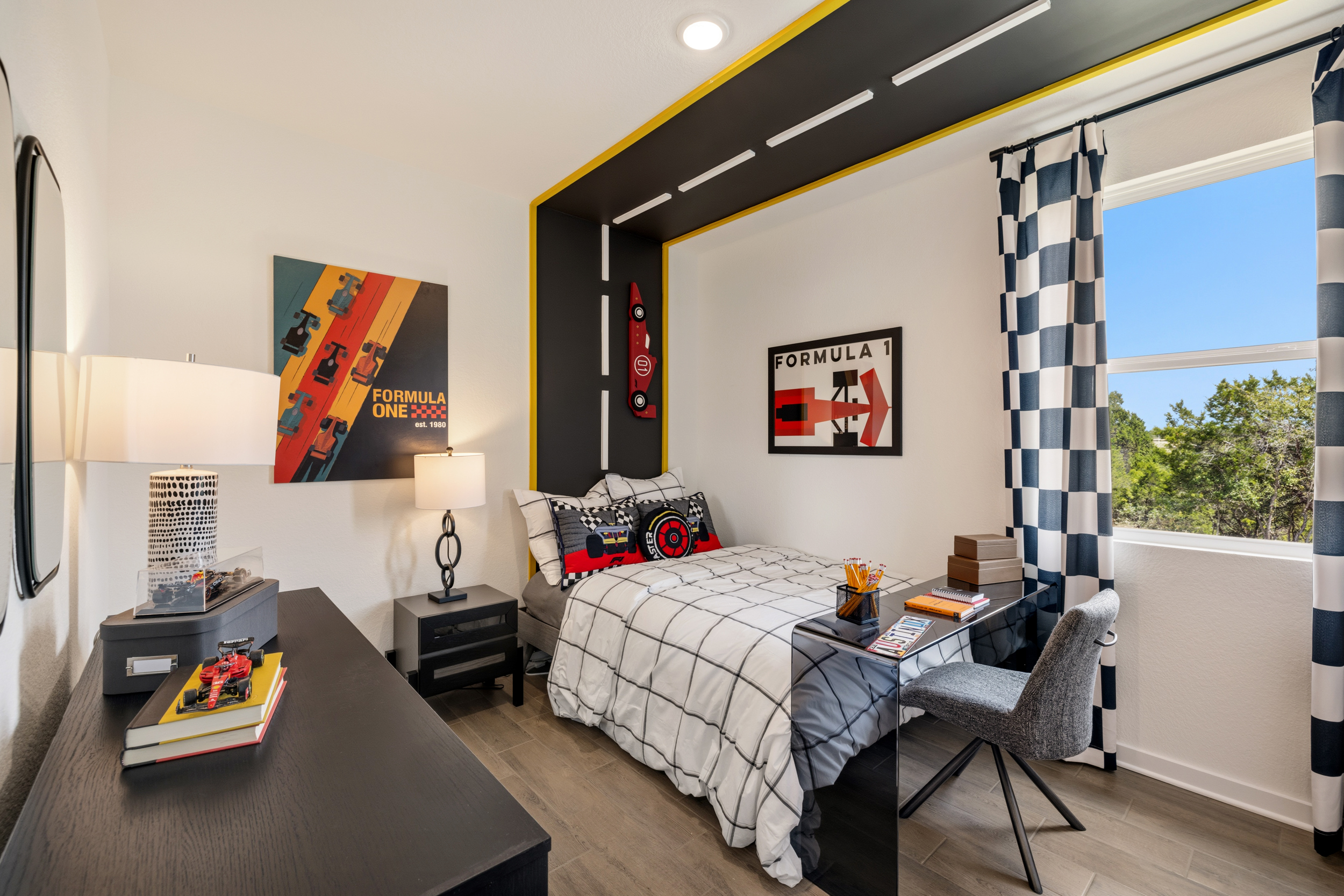 A bedroom with a desk and chair.