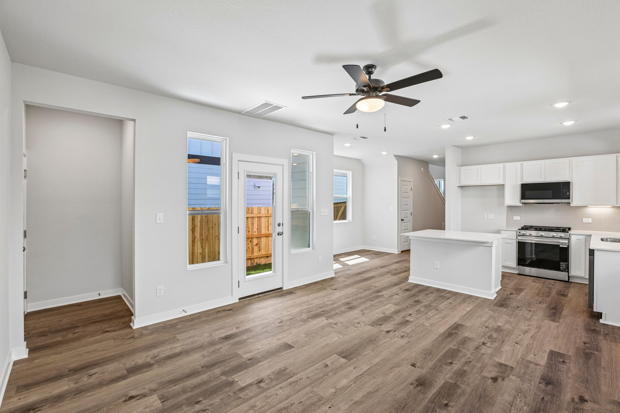 A kitchen with white cabinets.