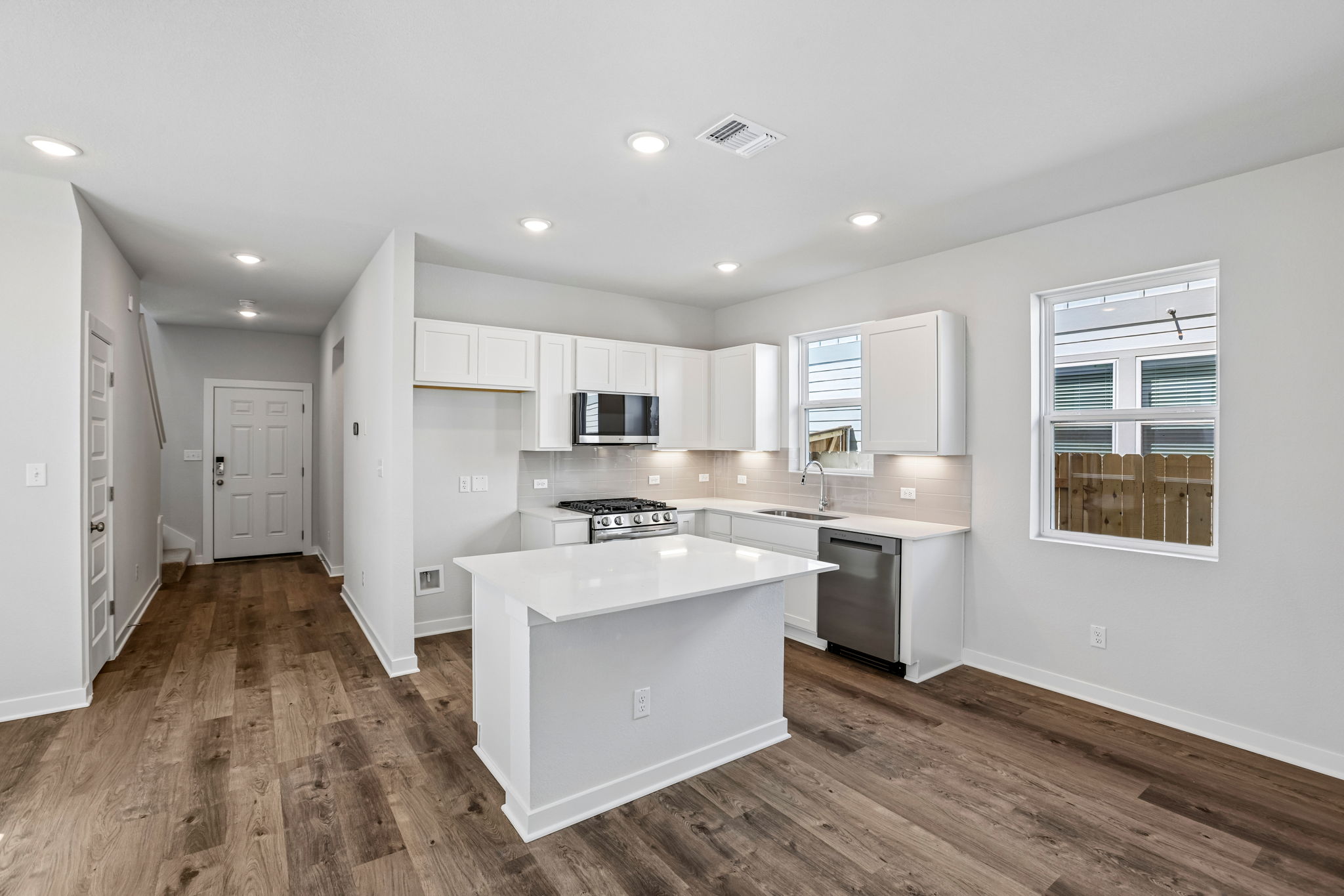 A kitchen with white cabinets.