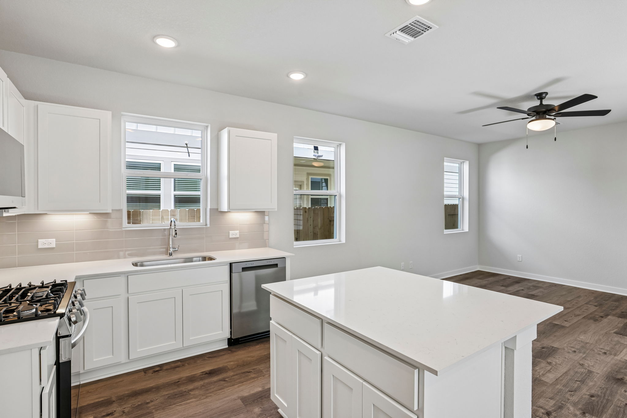 A kitchen with white cabinets.