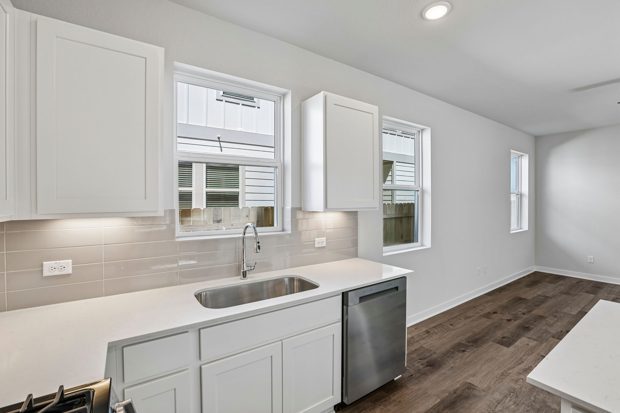 A kitchen with white cabinets.