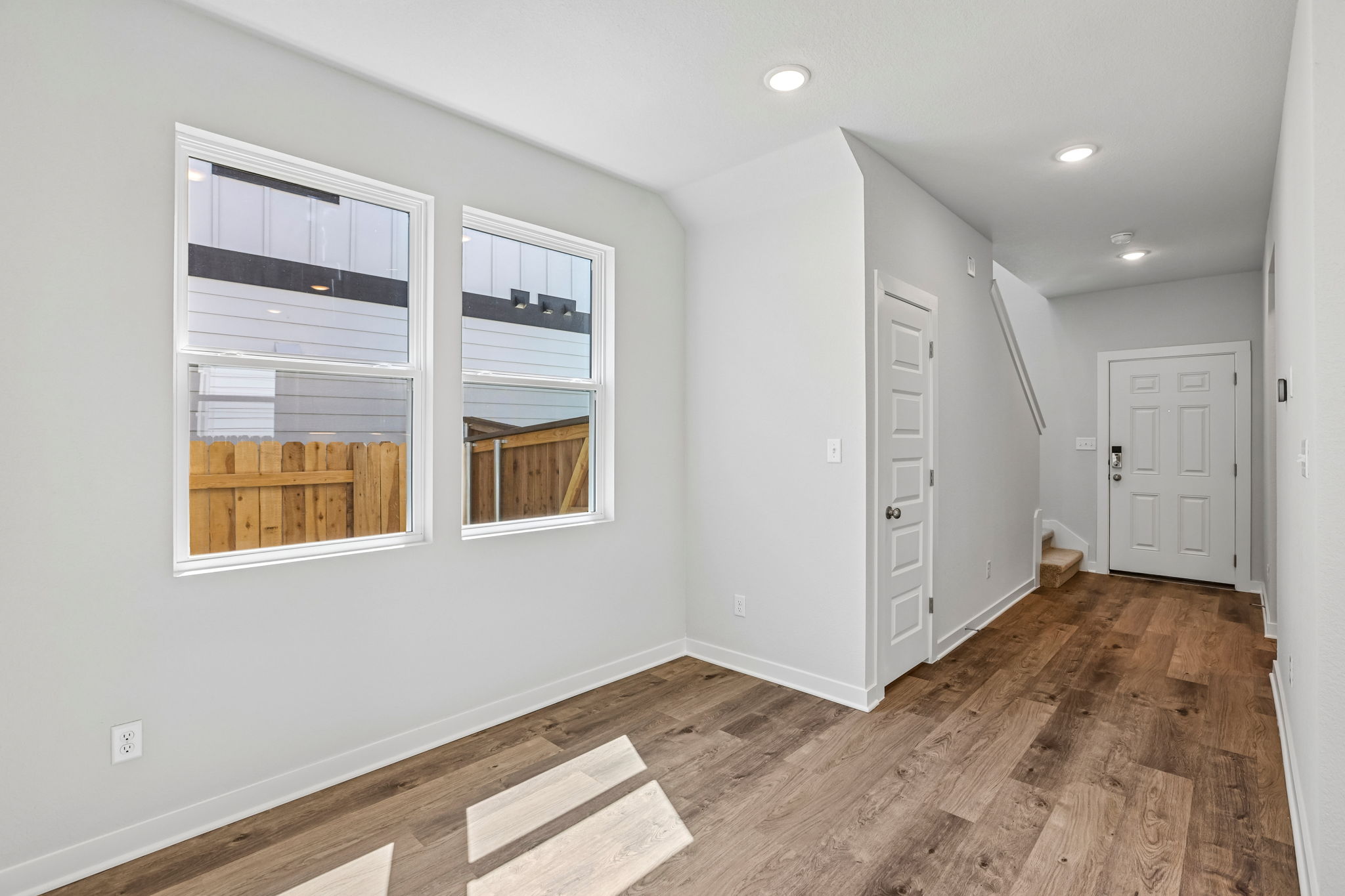 A room with white walls and a wood floor.