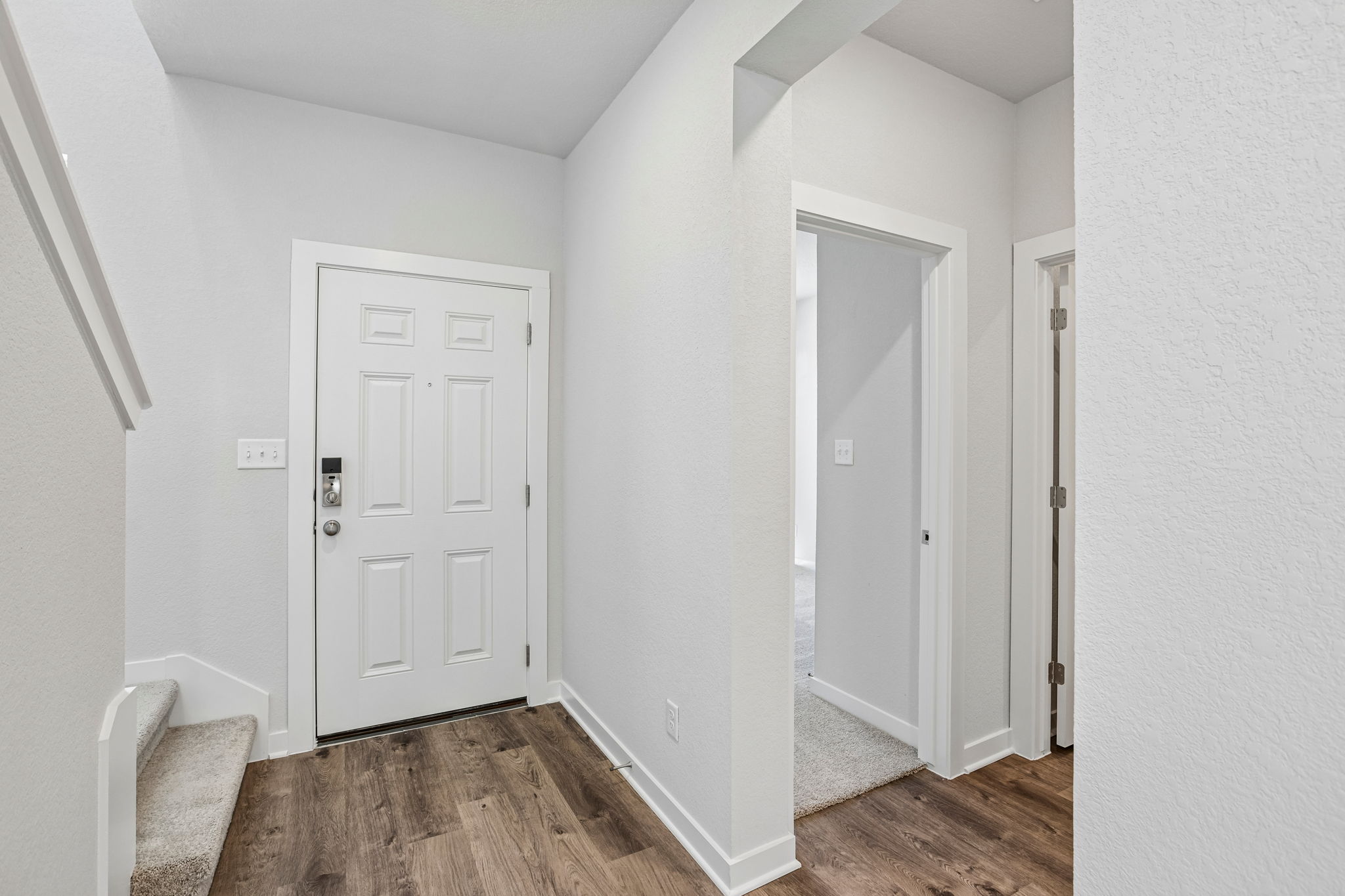 A hallway with white doors.