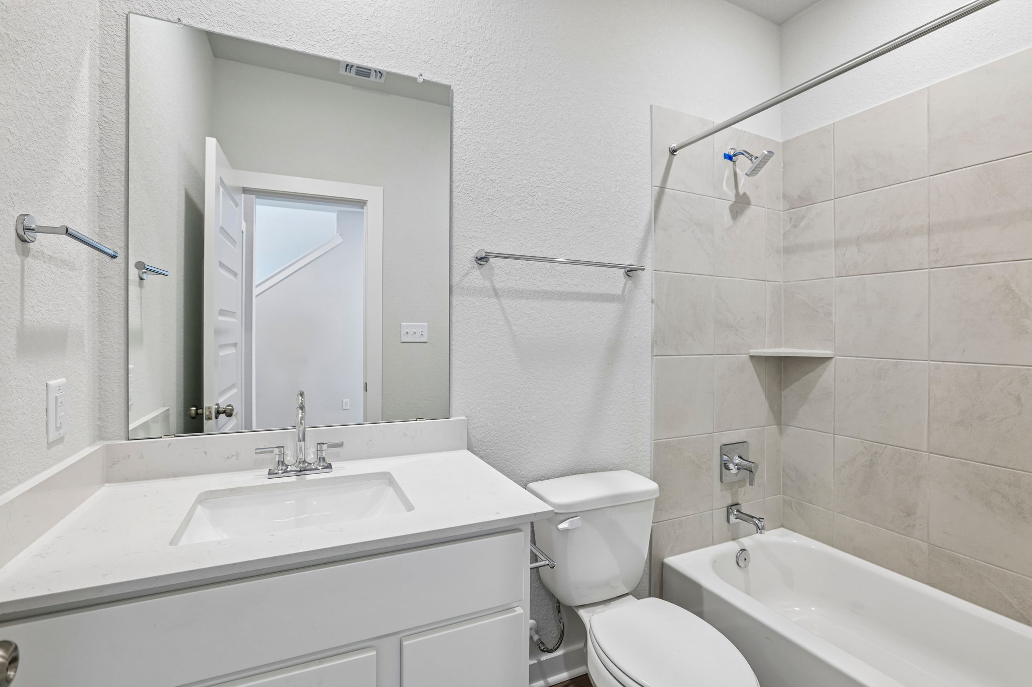 A bathroom with a tub toilet and sink.