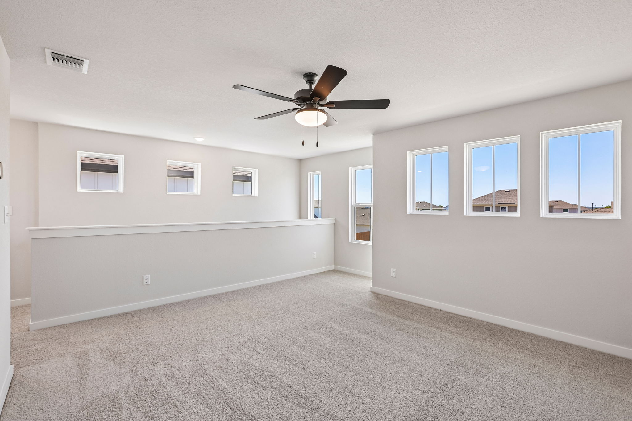 A room with a ceiling fan and a window.