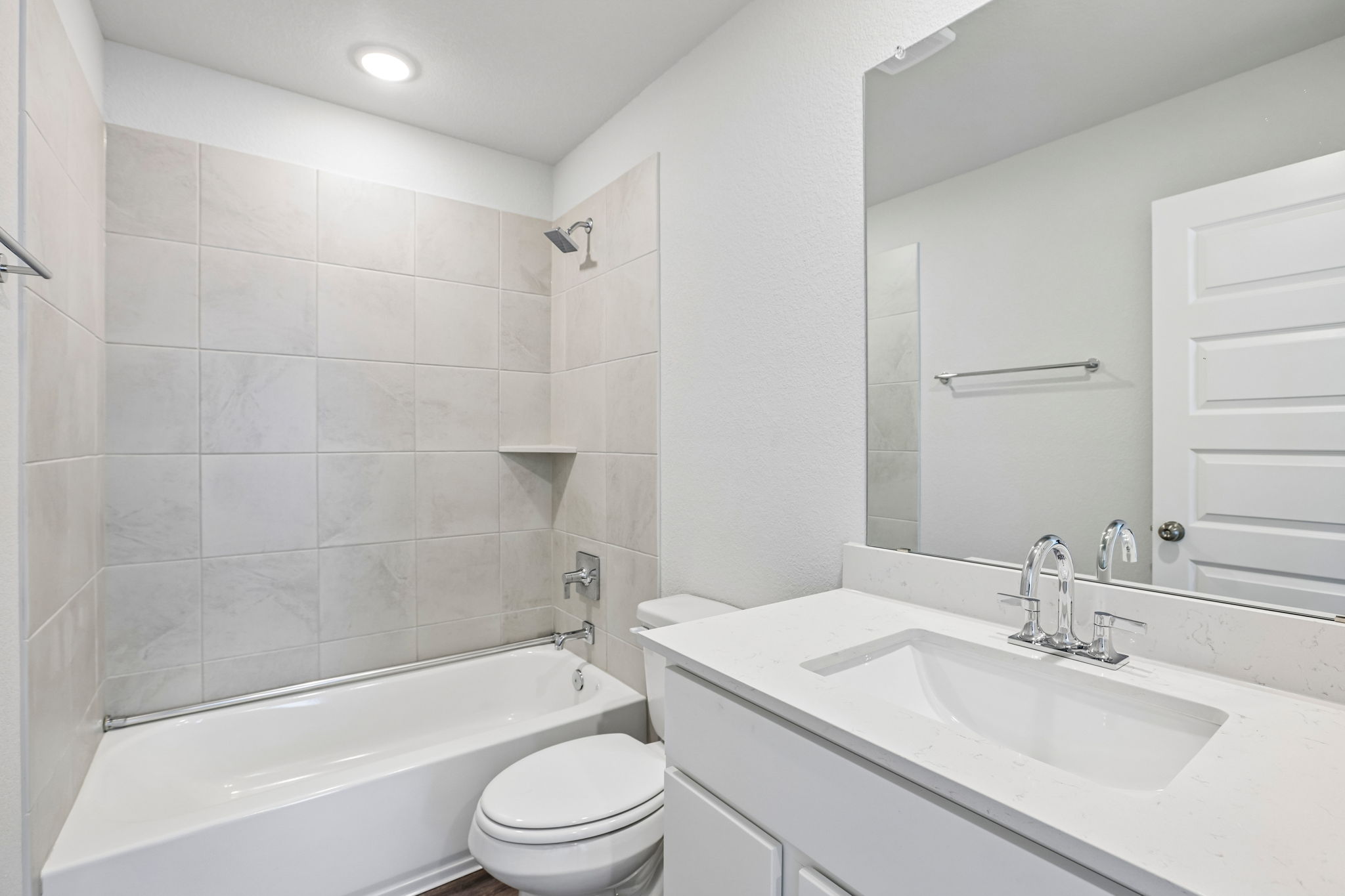 A bathroom with a tub sink and toilet.