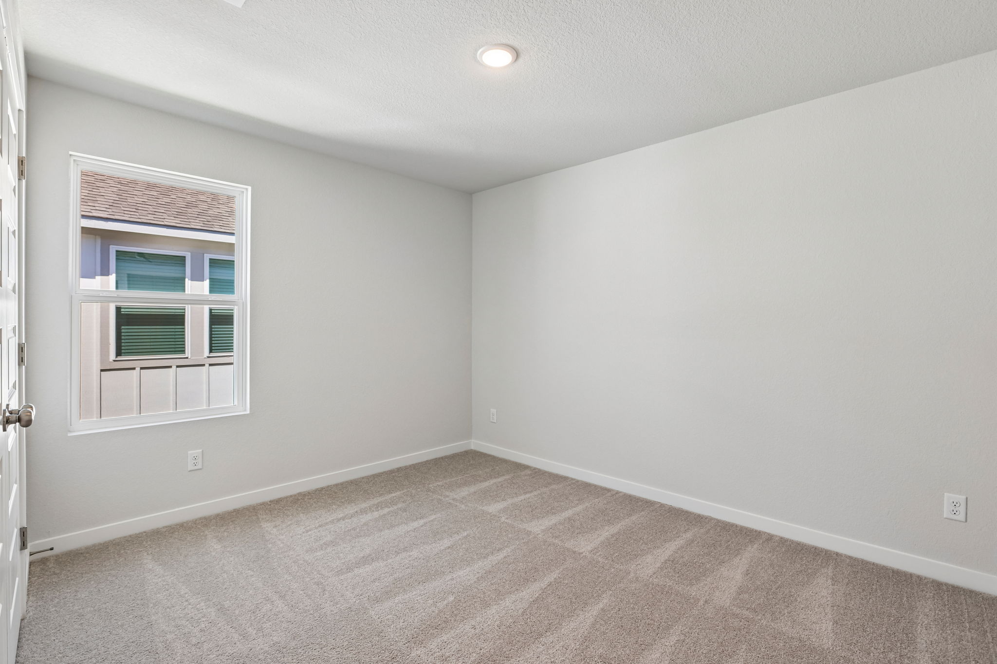 A room with a window and a door.