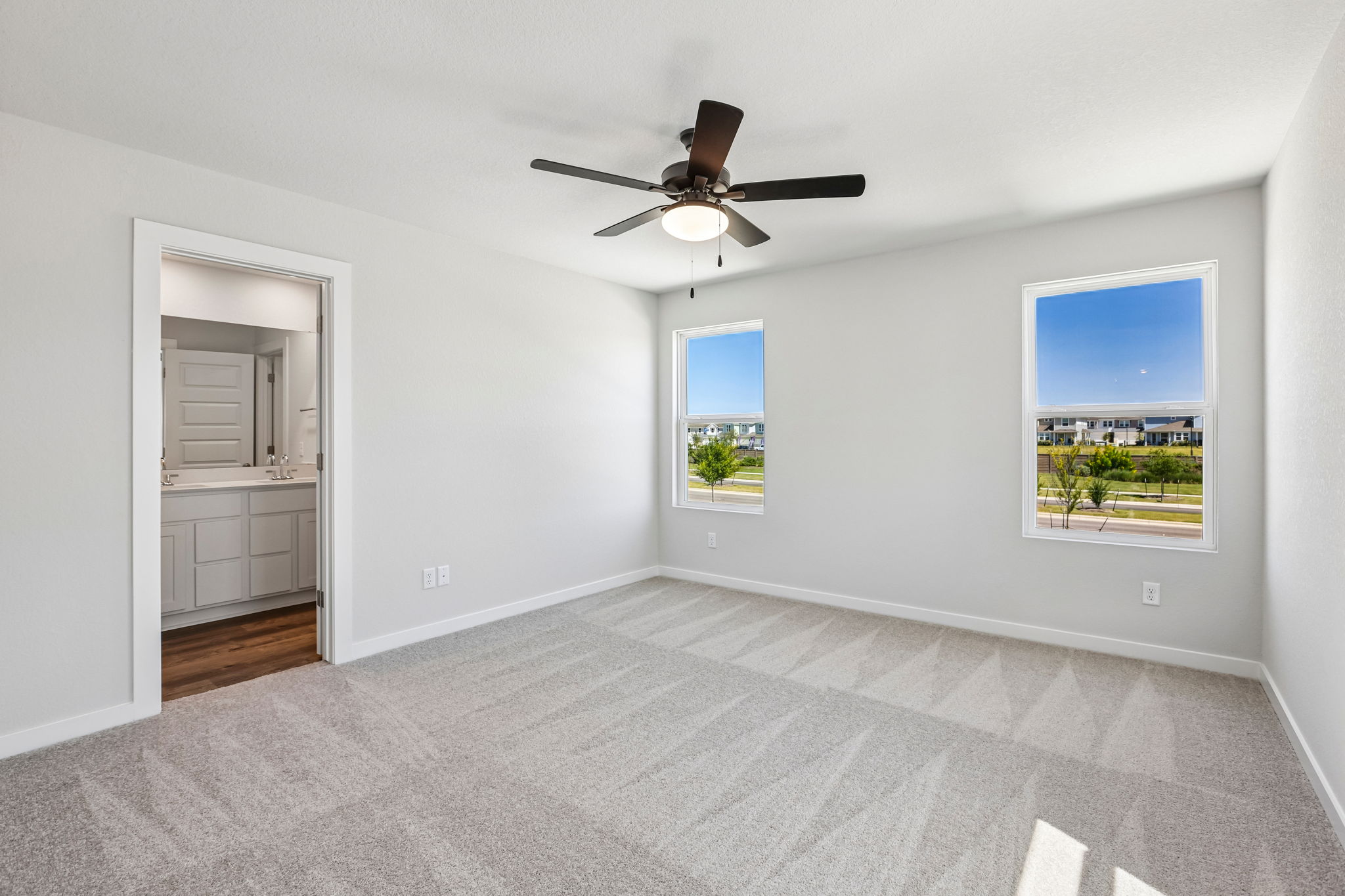 A room with a ceiling fan and a window.