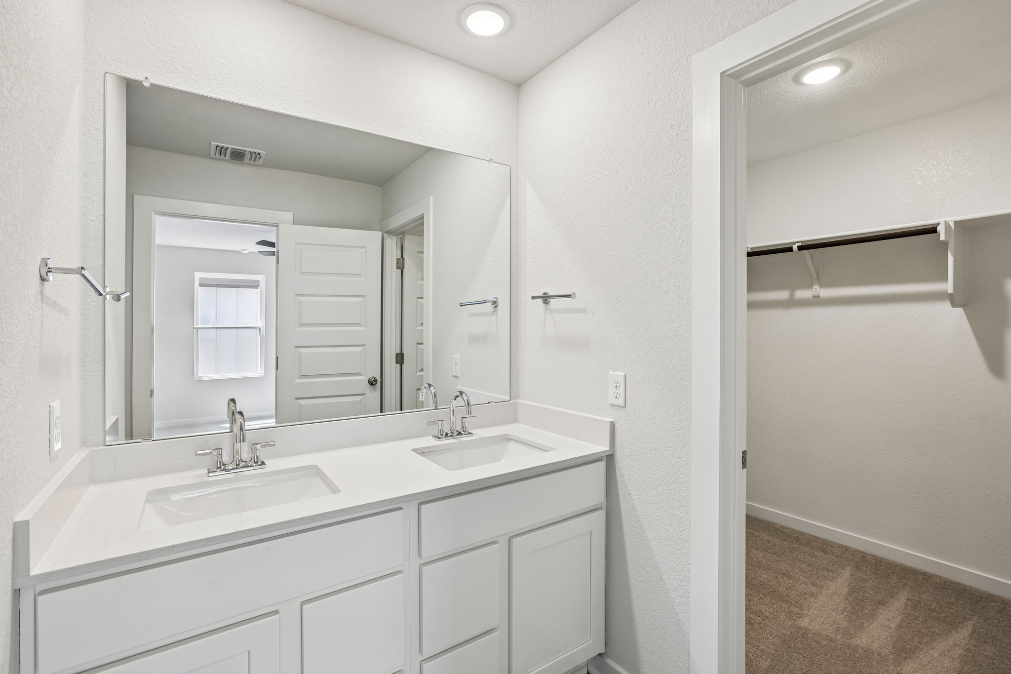 A bathroom with a large mirror.