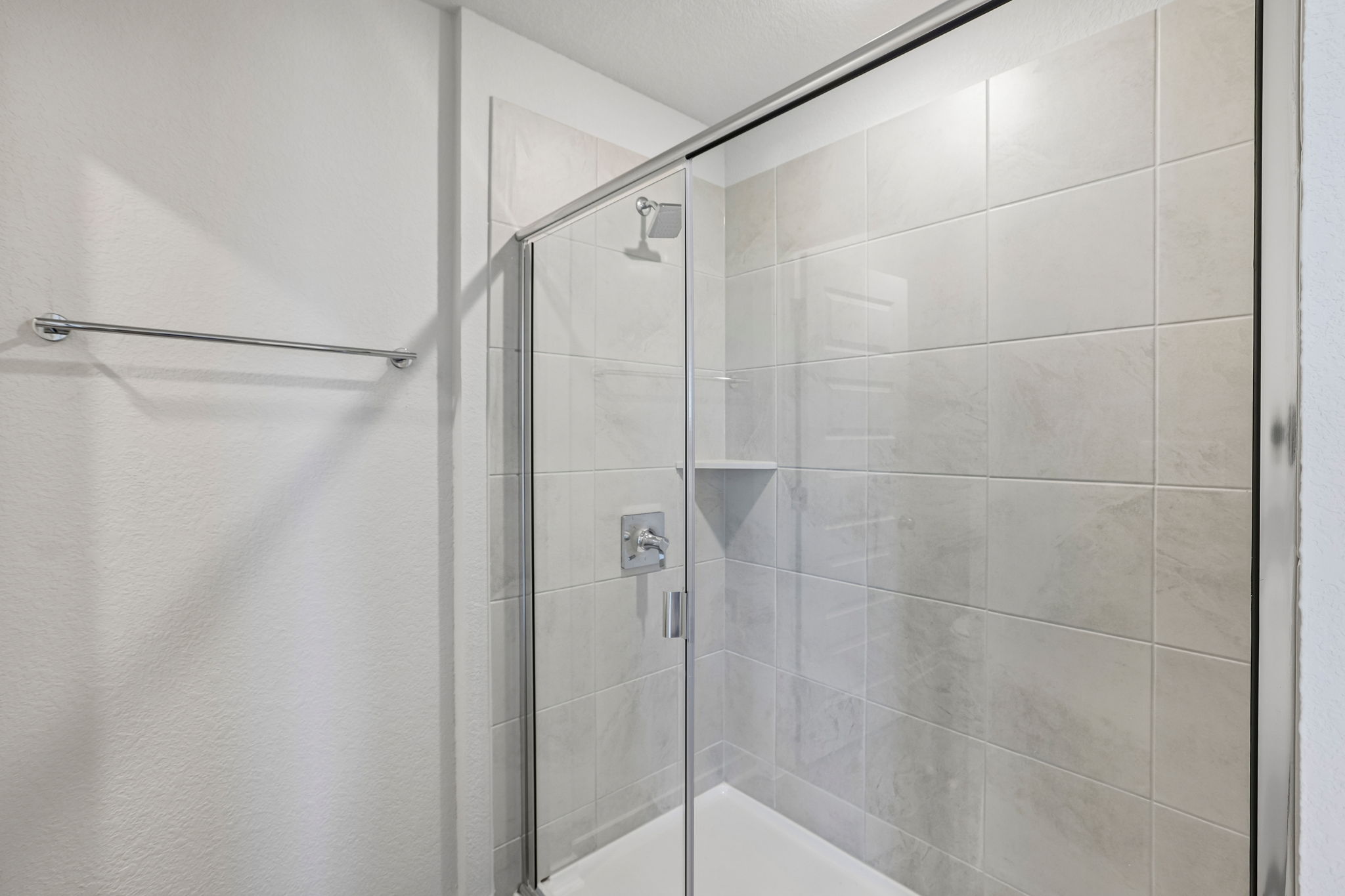 A shower with a glass door.