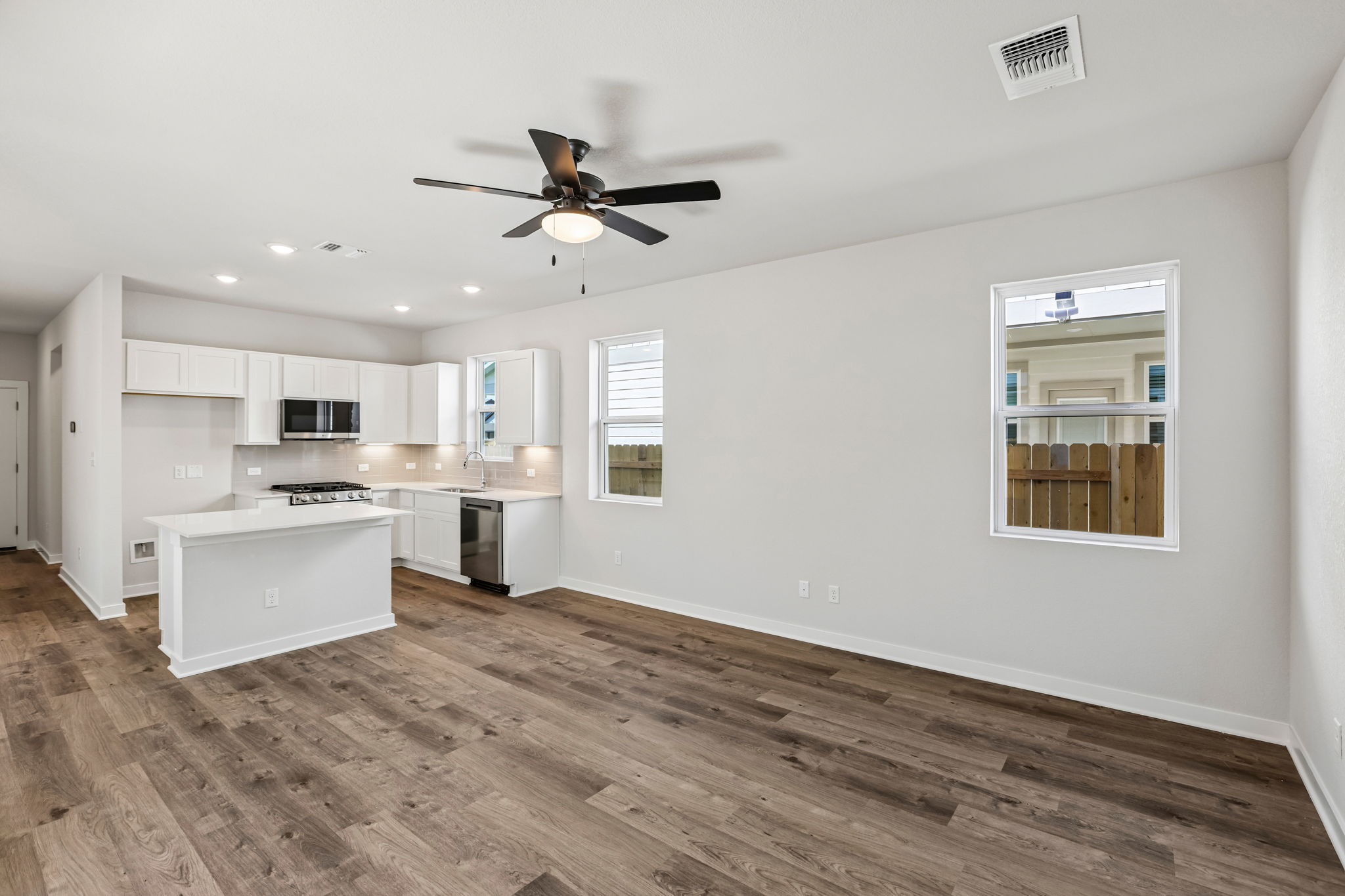 A kitchen with white cabinets.