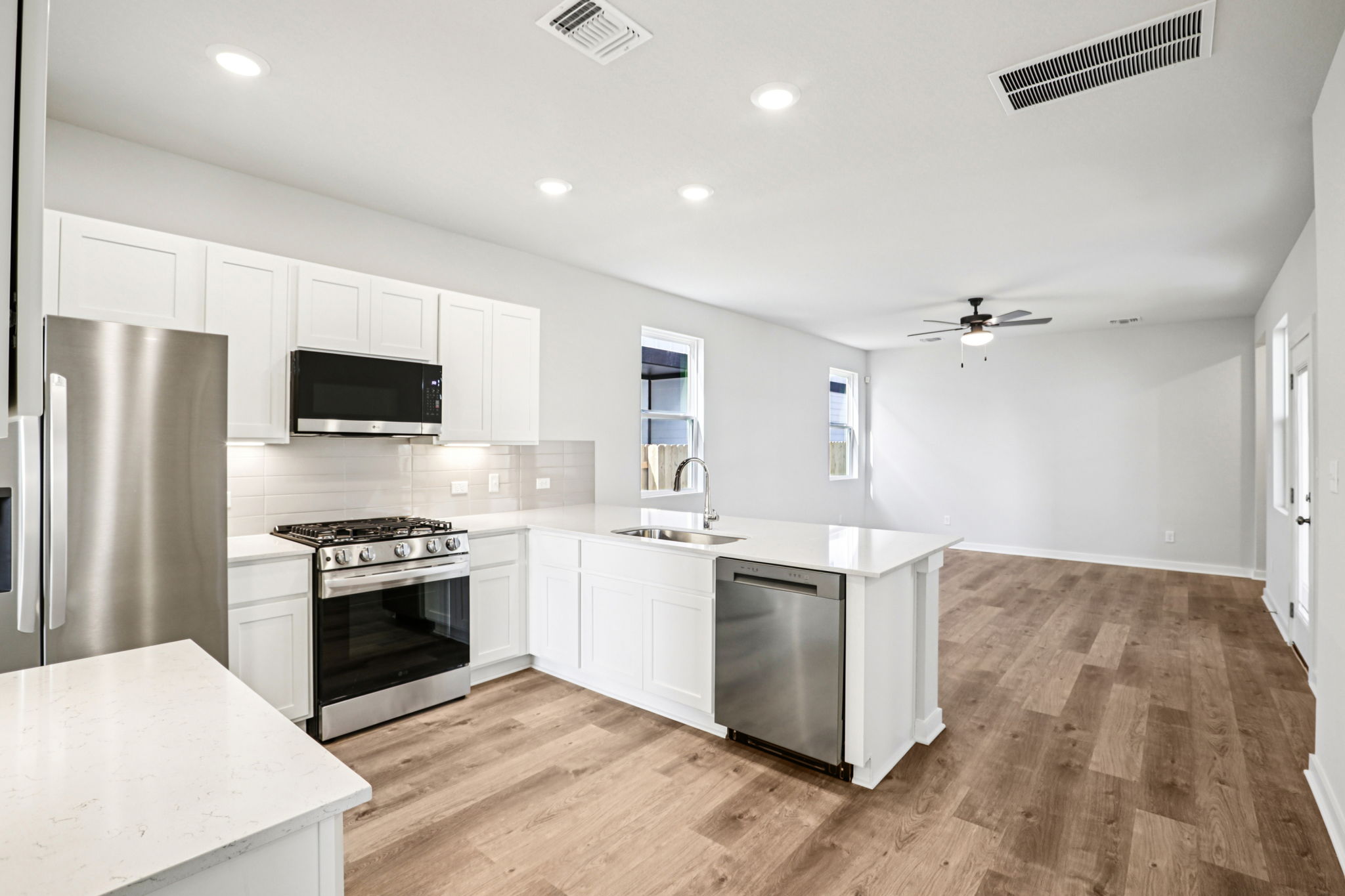 A kitchen with white cabinets.
