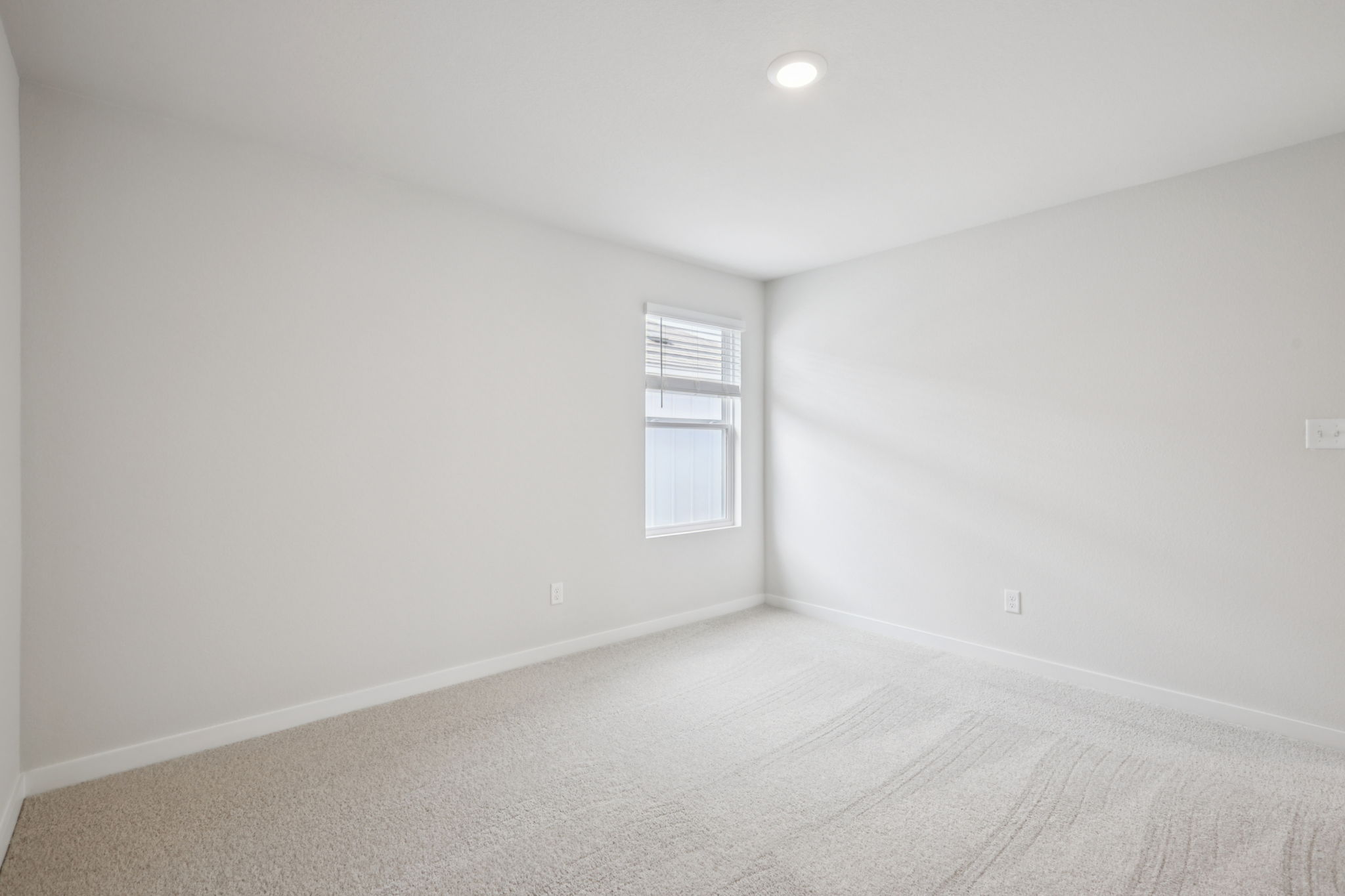 A room with a bed and a window.