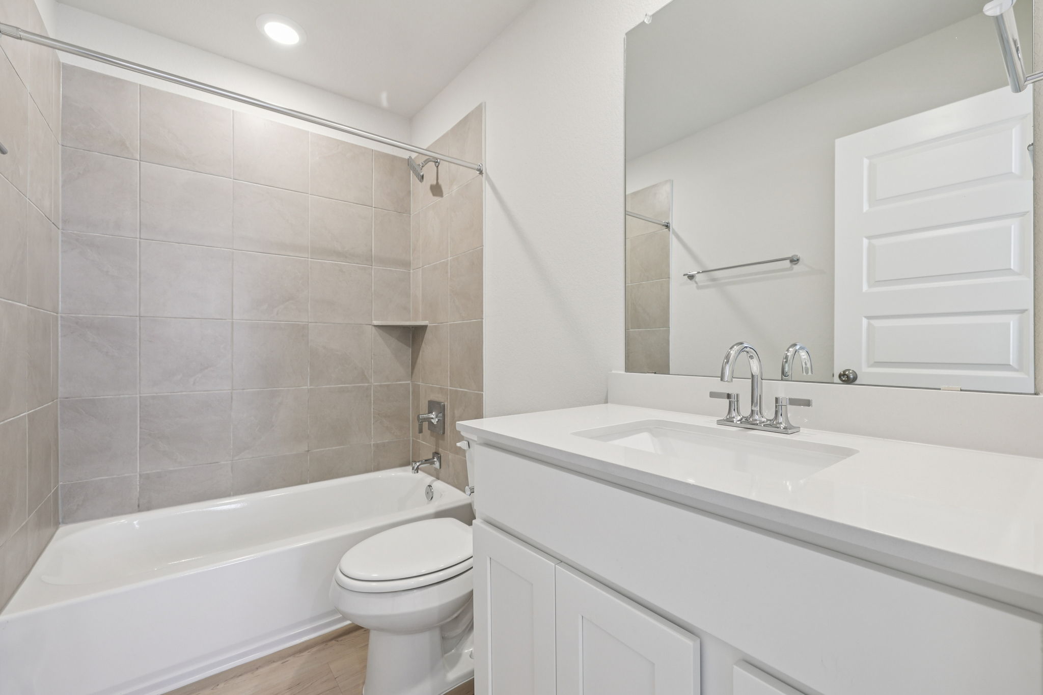 A bathroom with a tub sink and toilet.