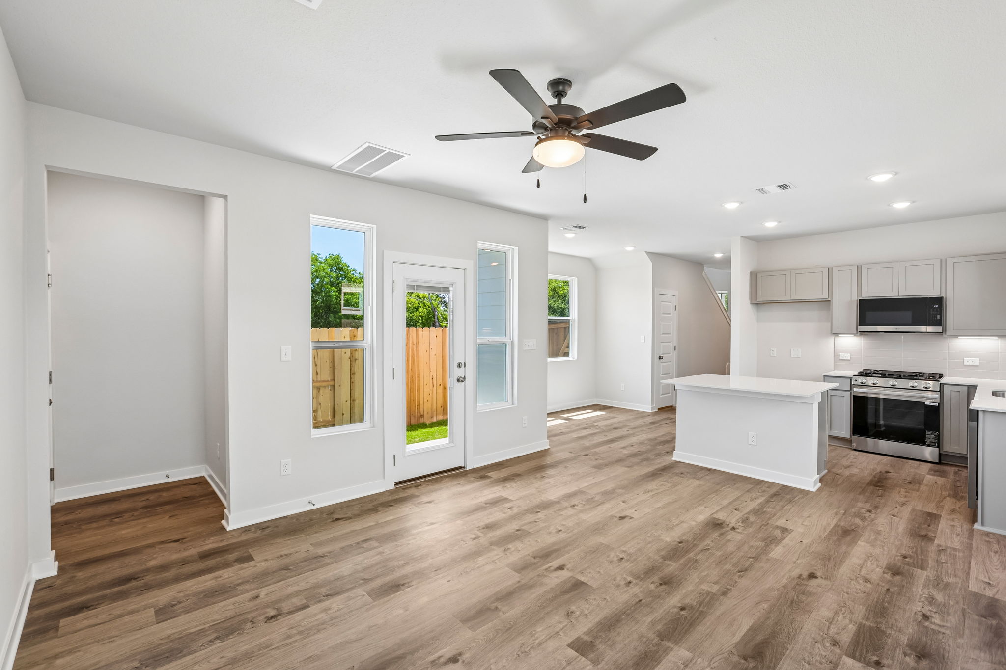 A kitchen with white cabinets.