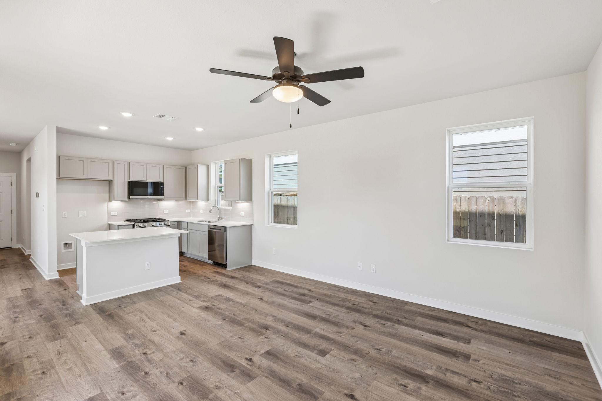 A kitchen with a ceiling fan.
