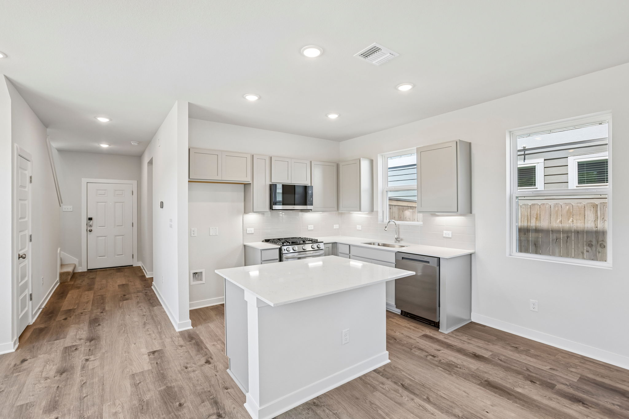 A kitchen with white cabinets.