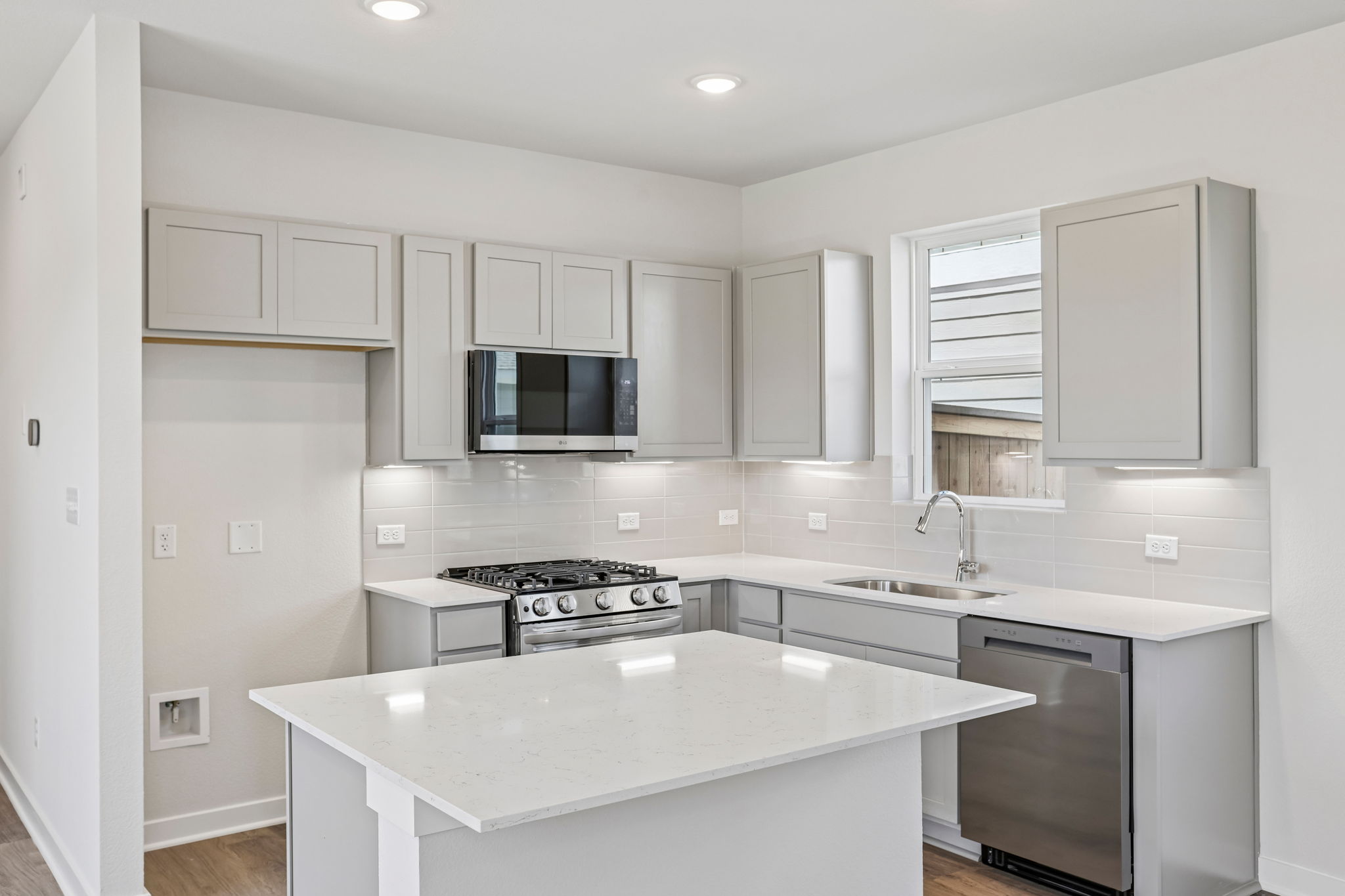 A kitchen with white cabinets.