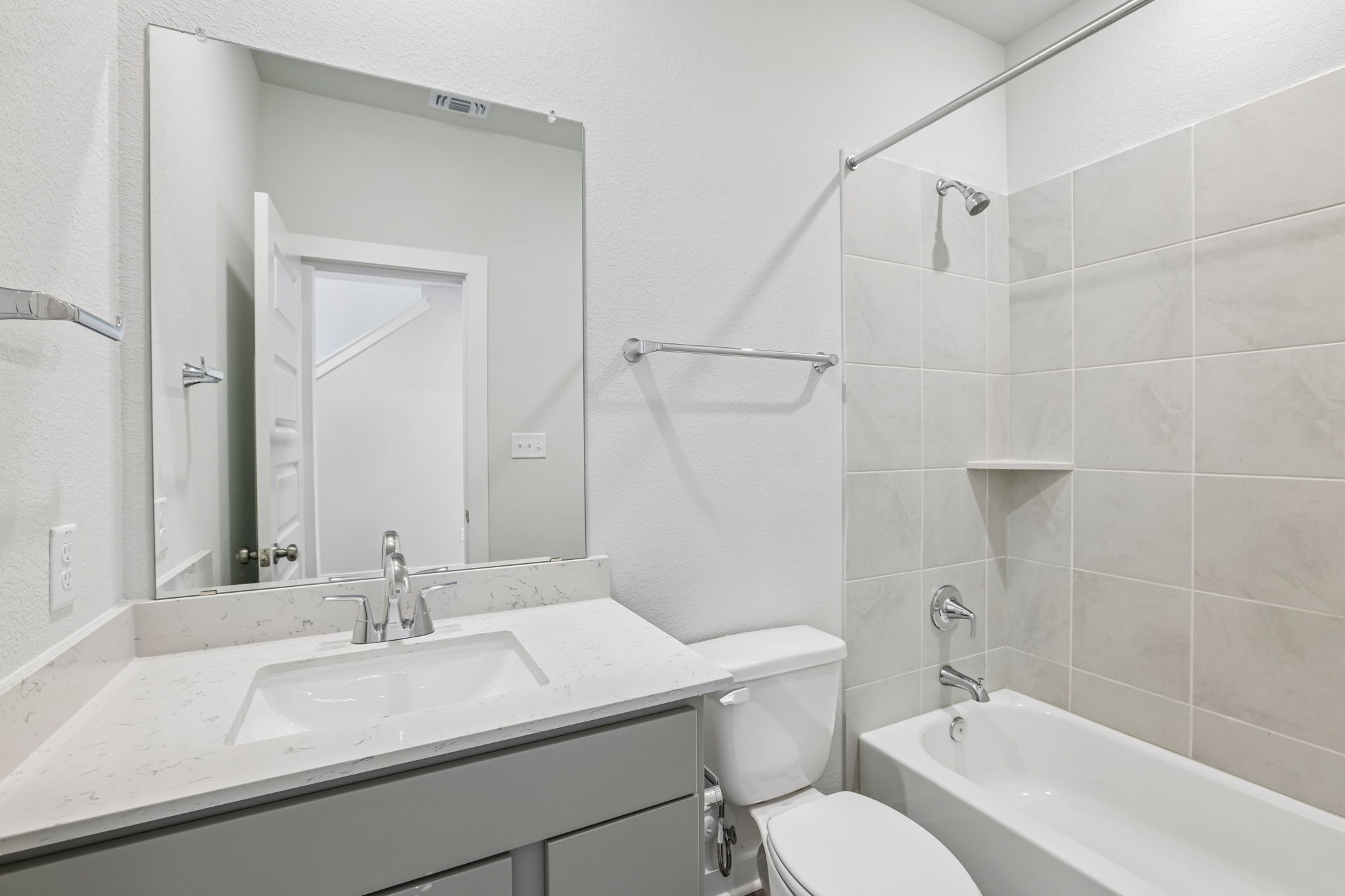 A bathroom with a sink toilet and bathtub.