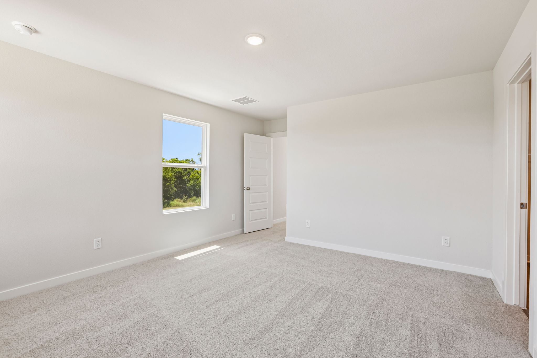 A room with a window and a door.