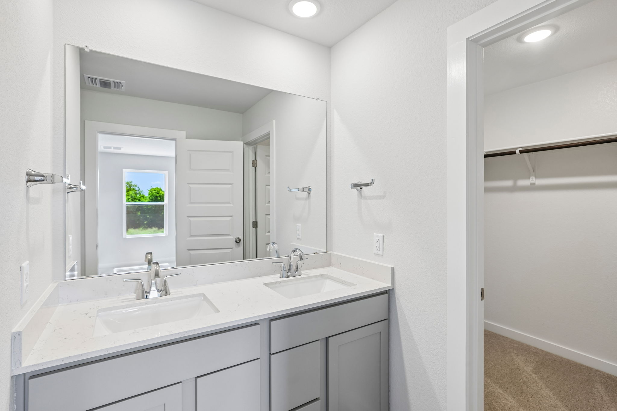 A bathroom with a large mirror.