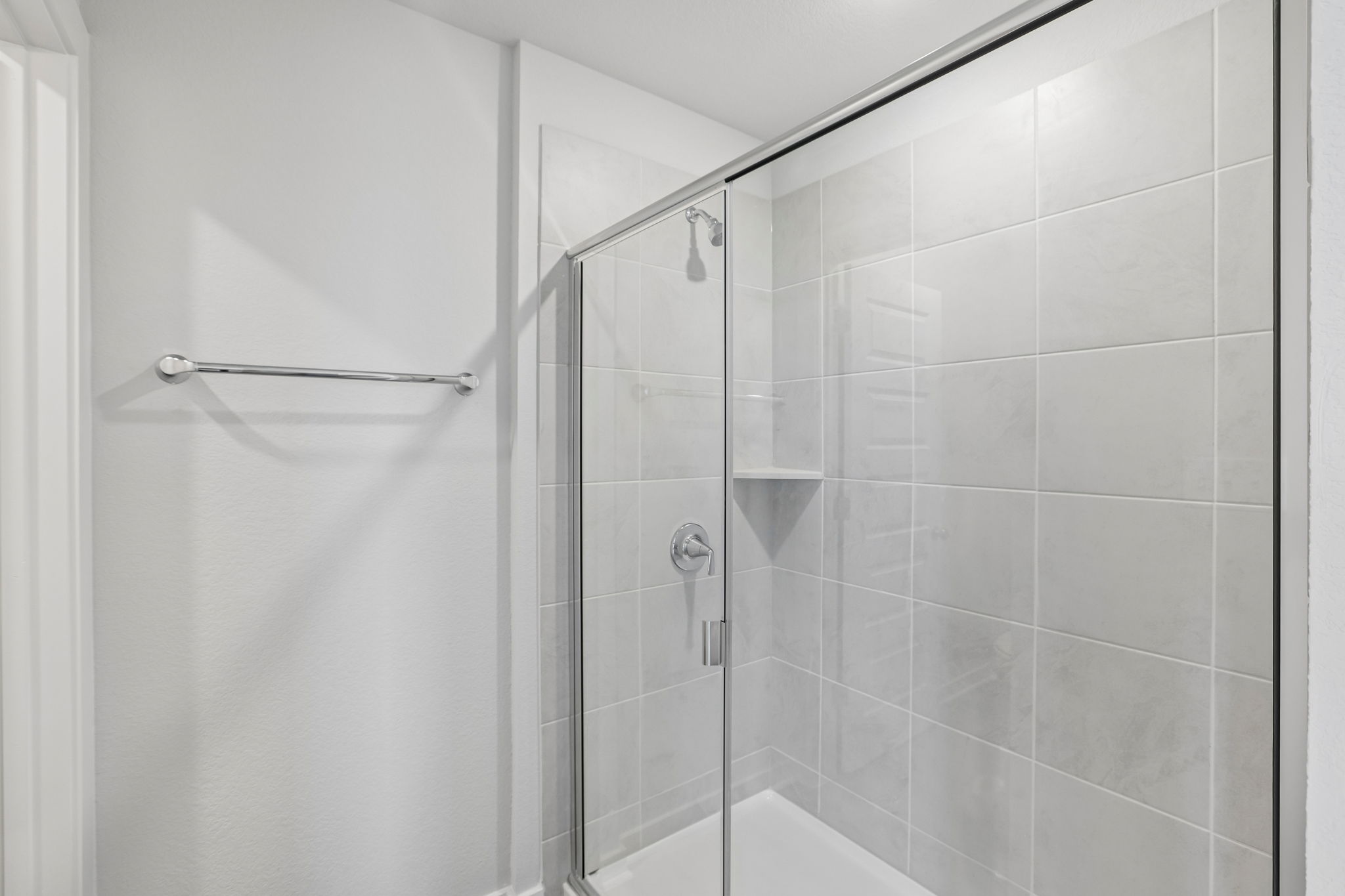 A shower with a glass door.