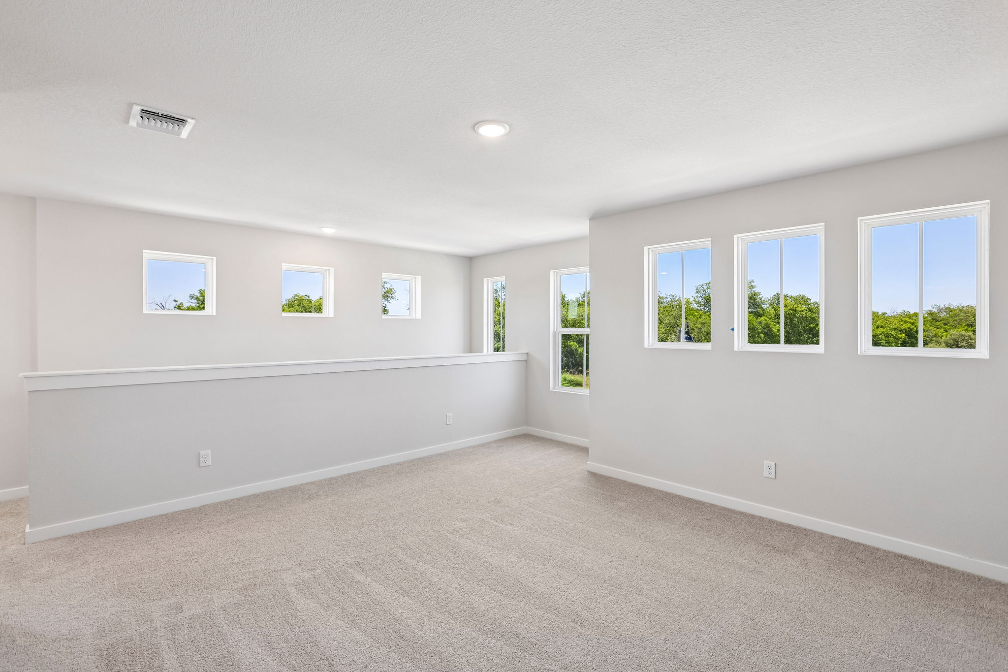 A room with white walls and windows.