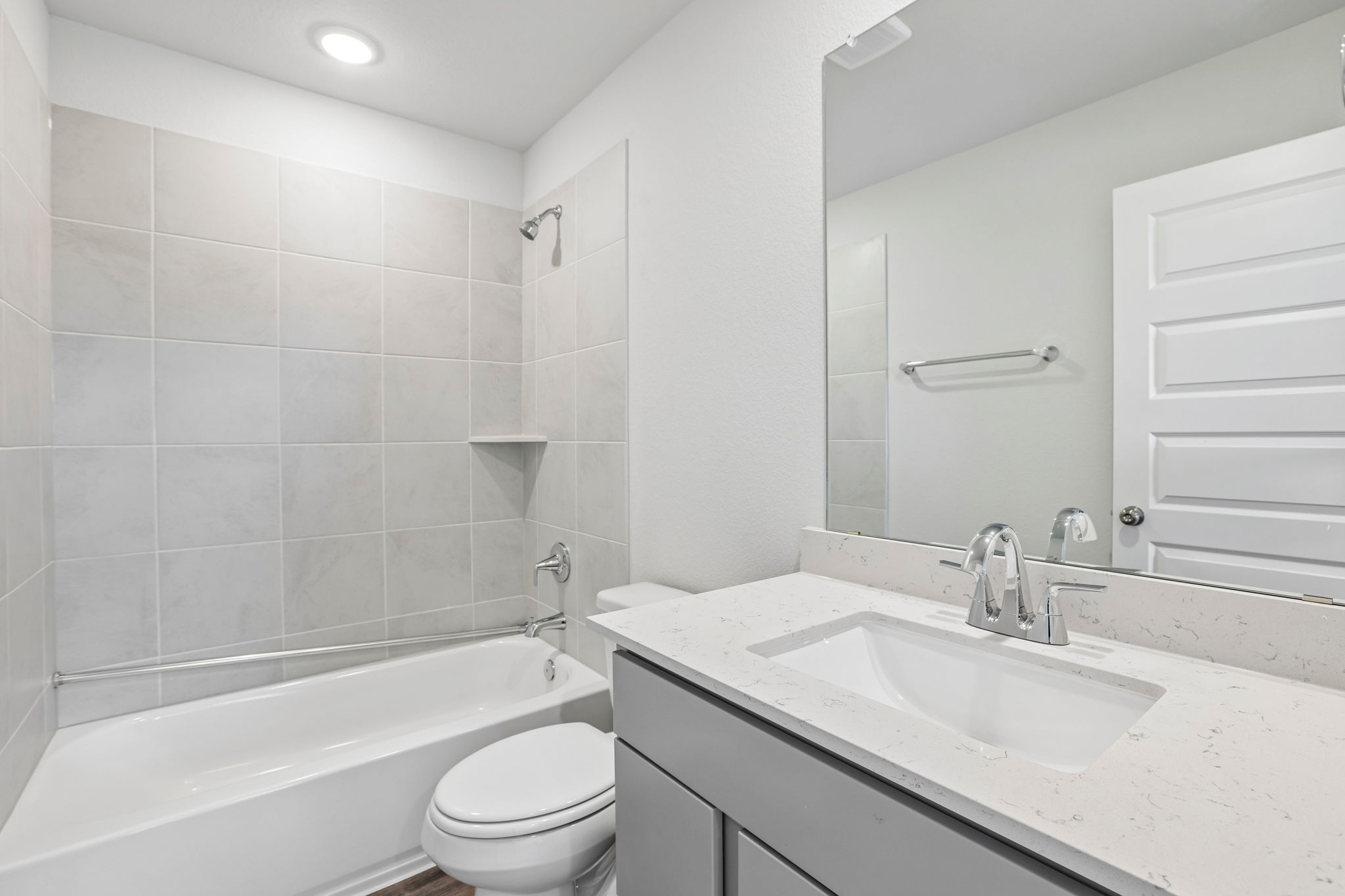A bathroom with a tub sink and toilet.