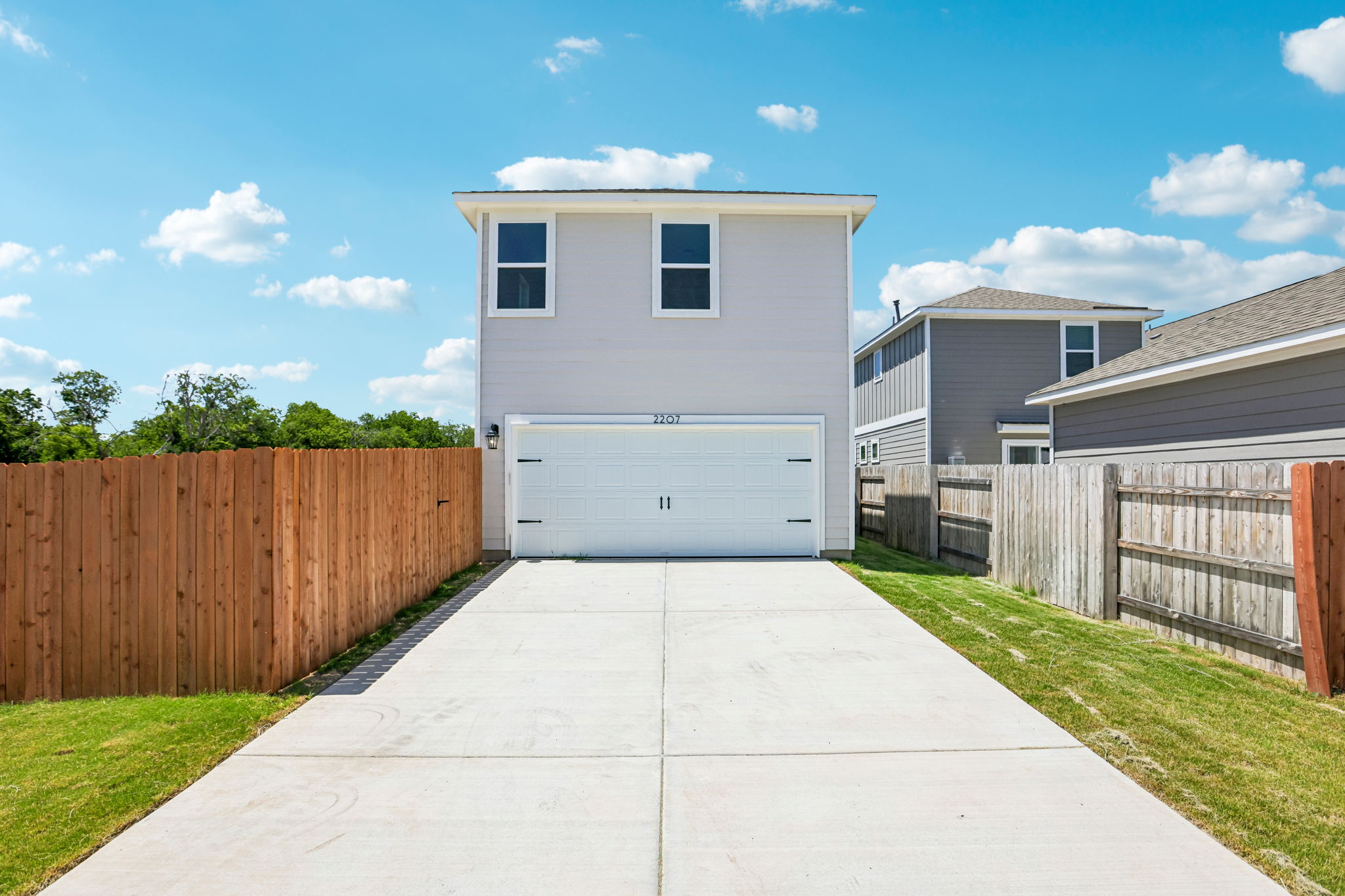 A driveway leading to a house.