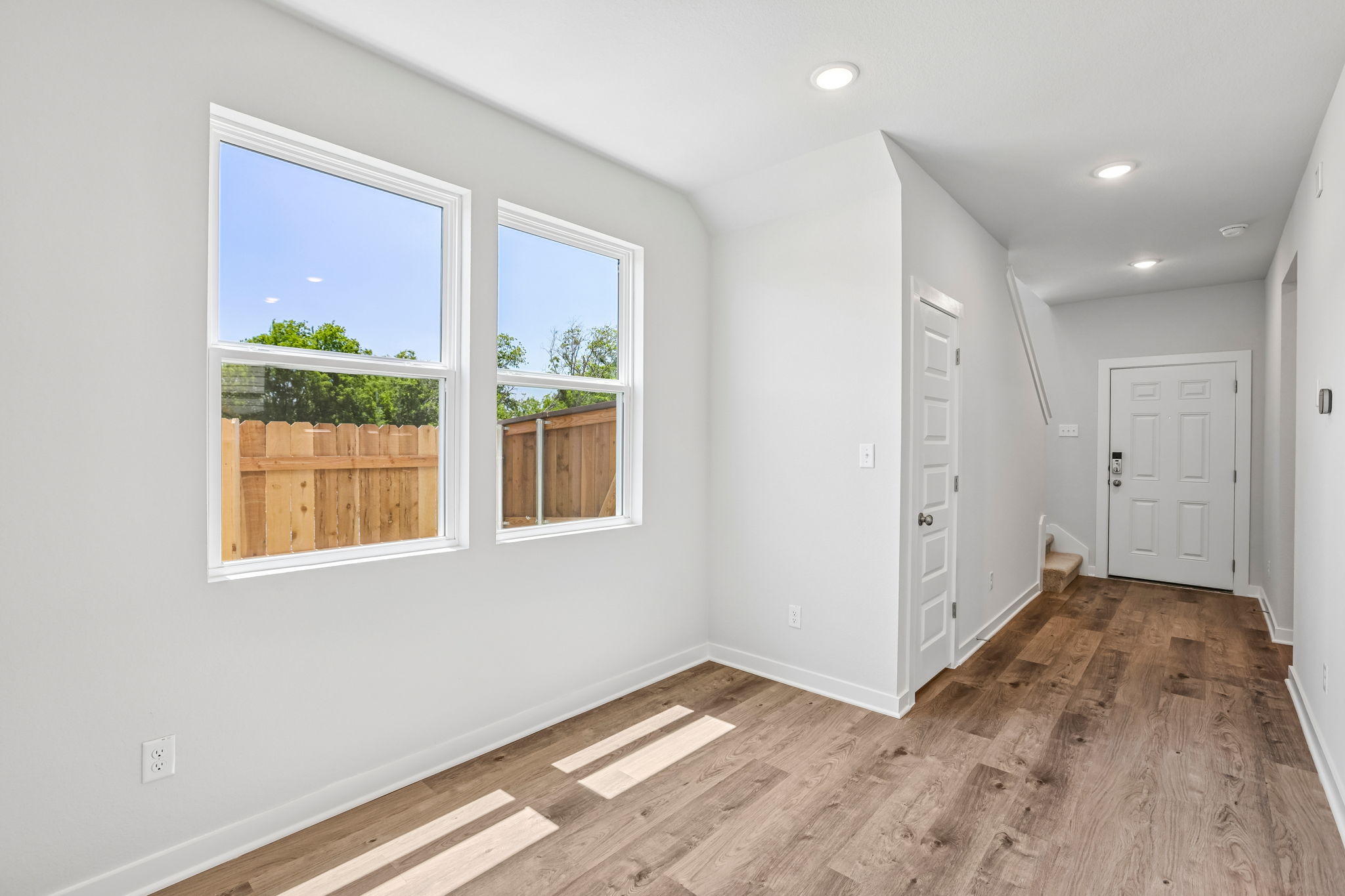A room with white walls and windows.