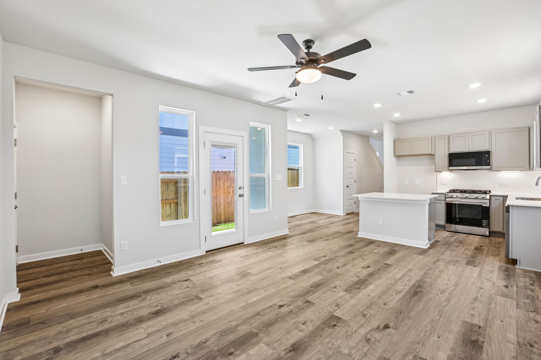 A kitchen with white cabinets.
