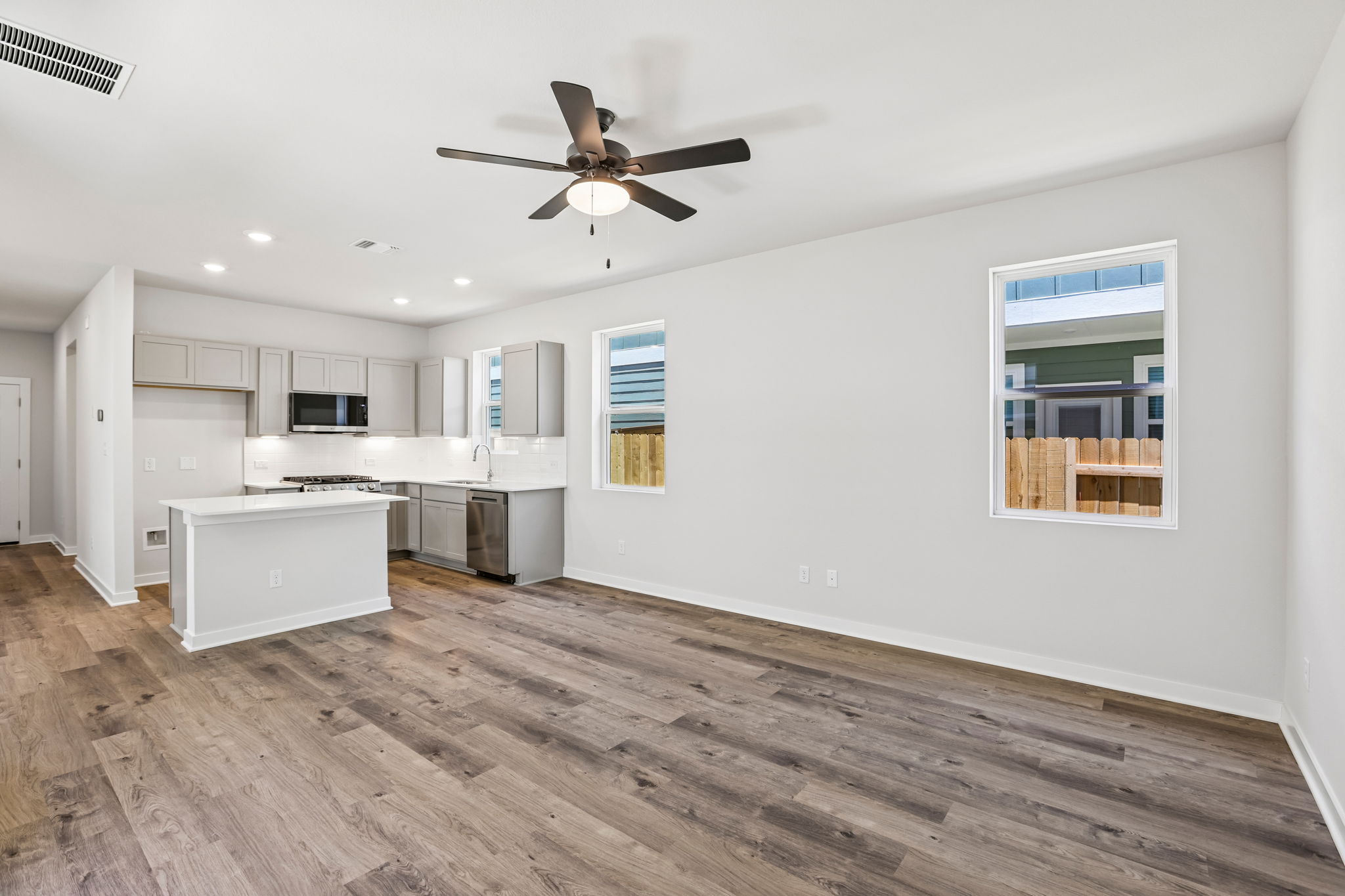 A kitchen with white cabinets.