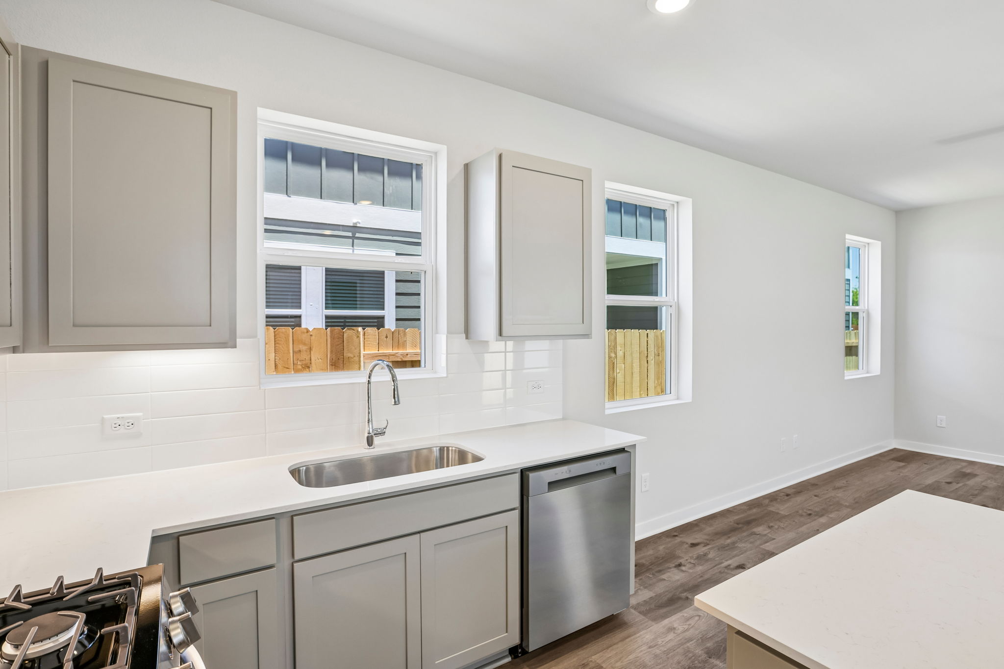 A kitchen with white cabinets.