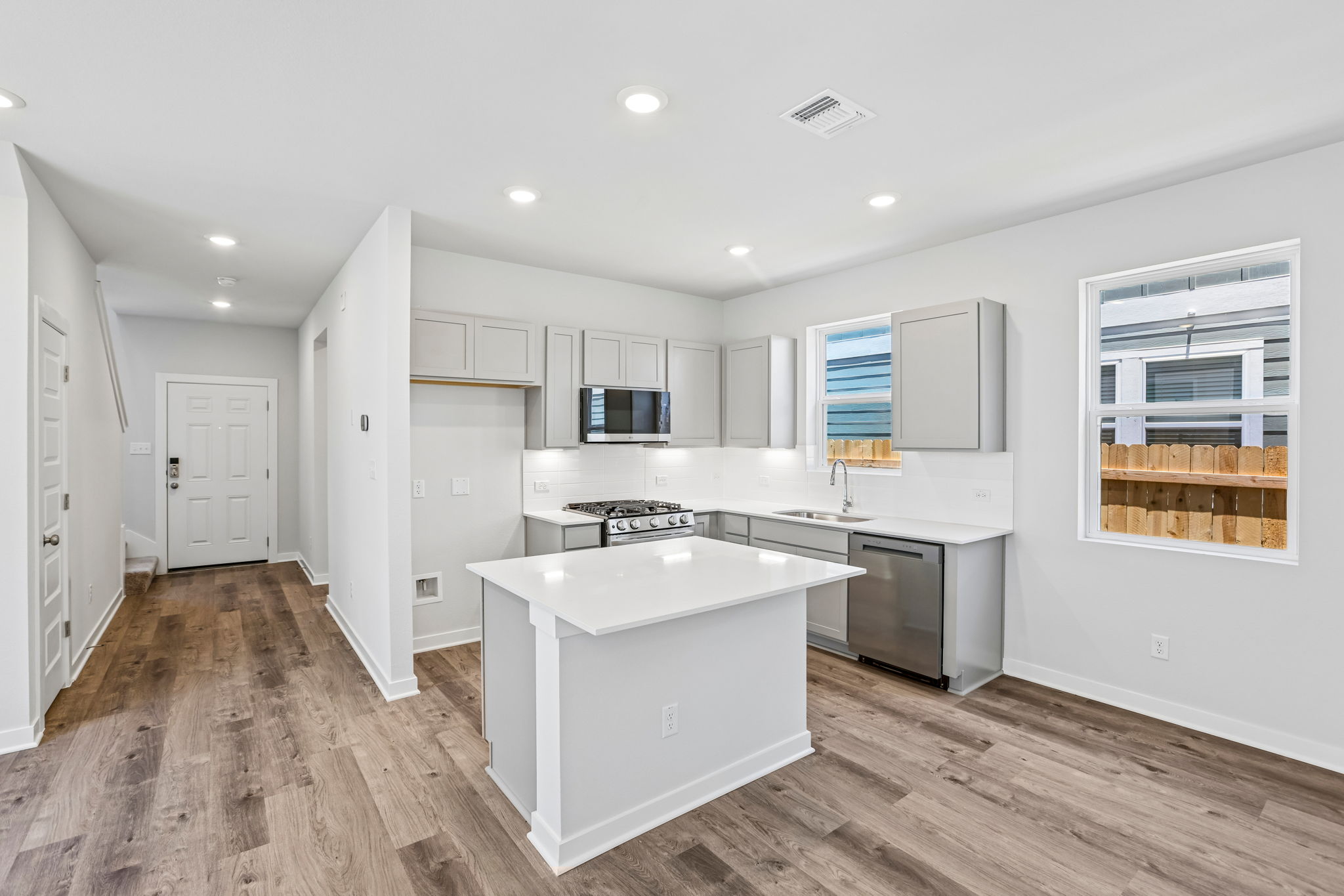 A kitchen with white cabinets.