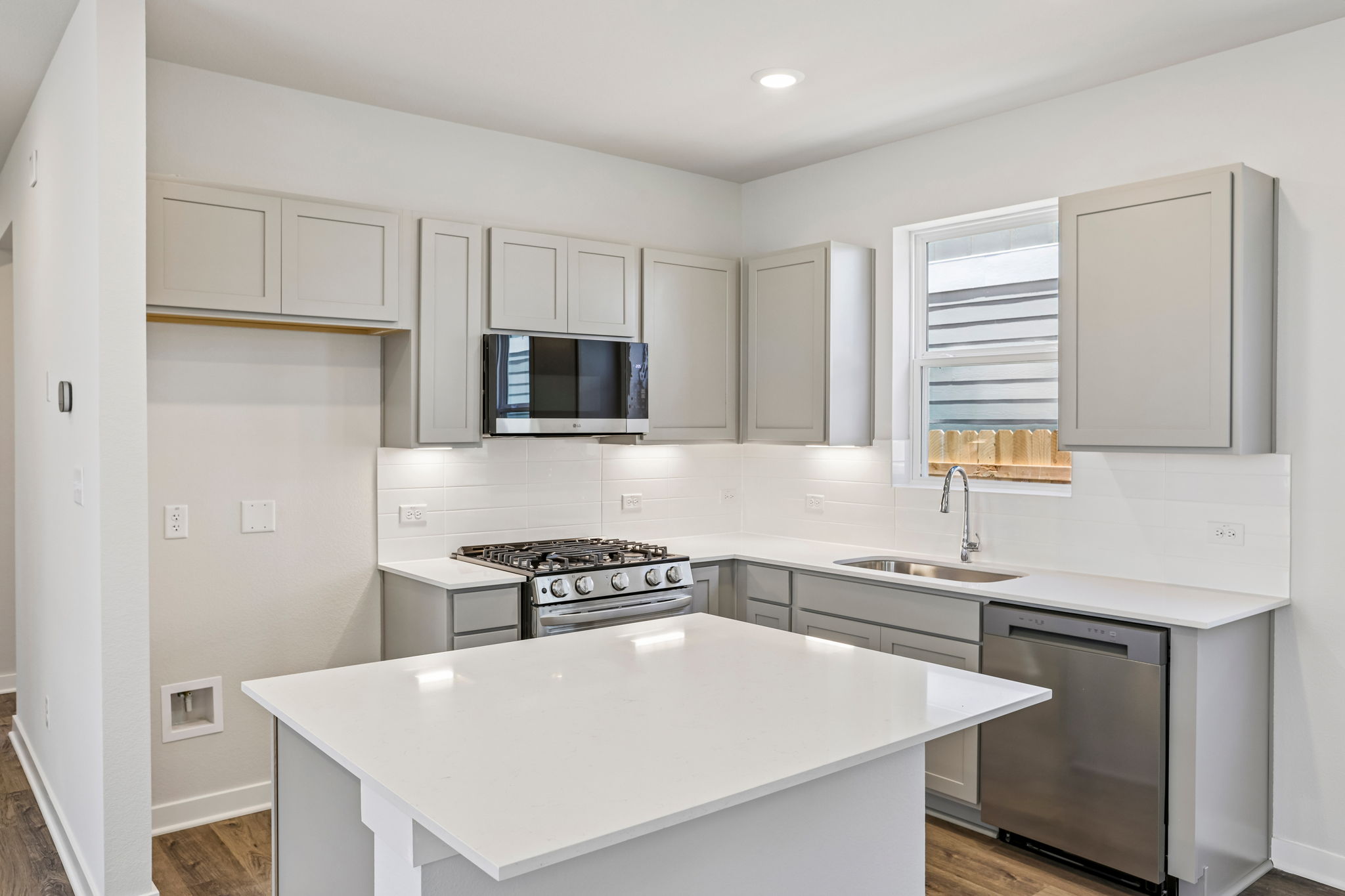 A kitchen with white cabinets.