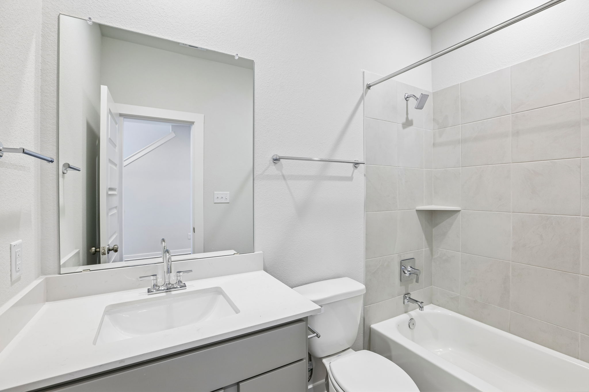 A bathroom with a sink toilet and bathtub.