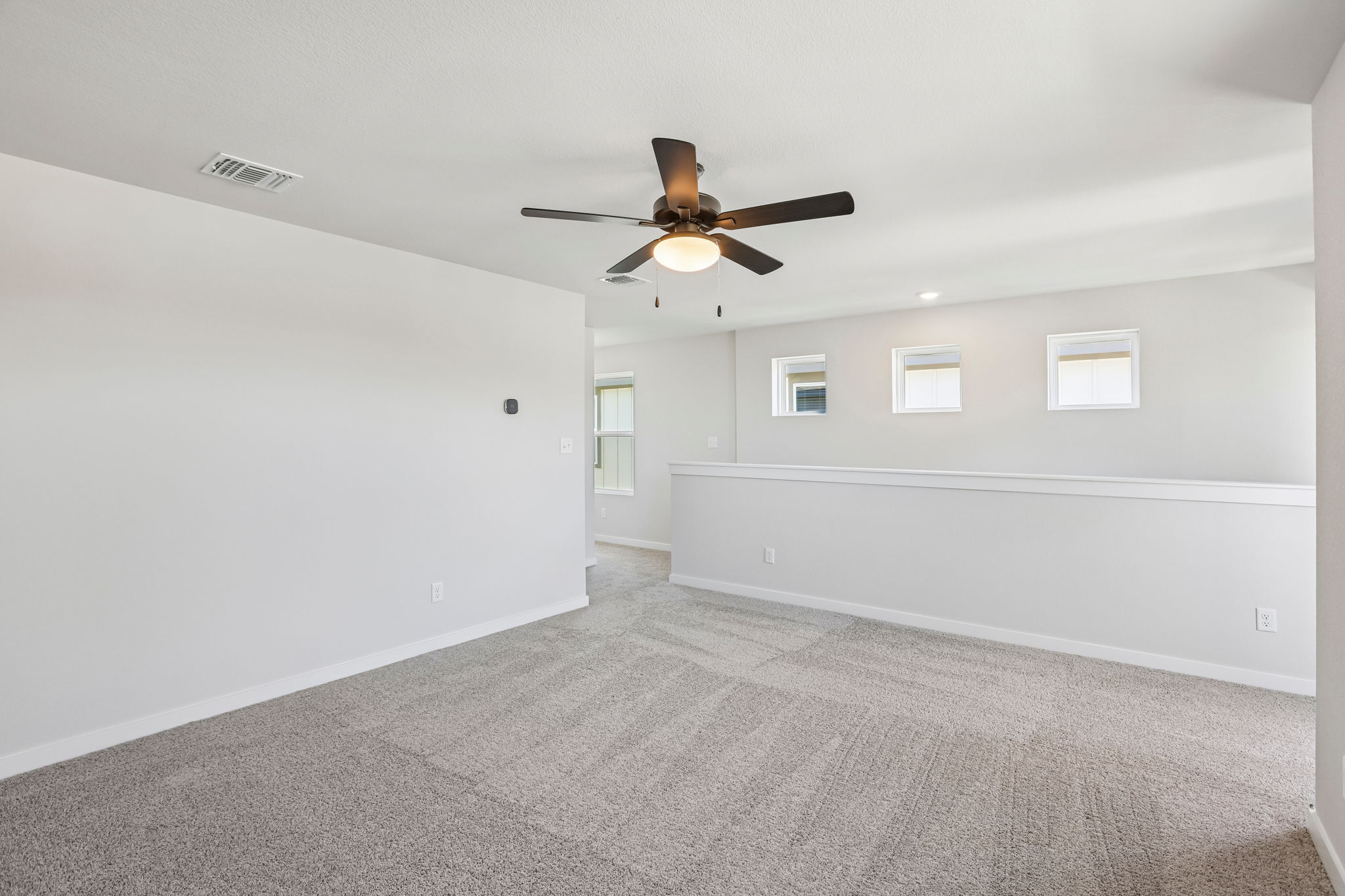 A room with a ceiling fan and a ceiling fan.