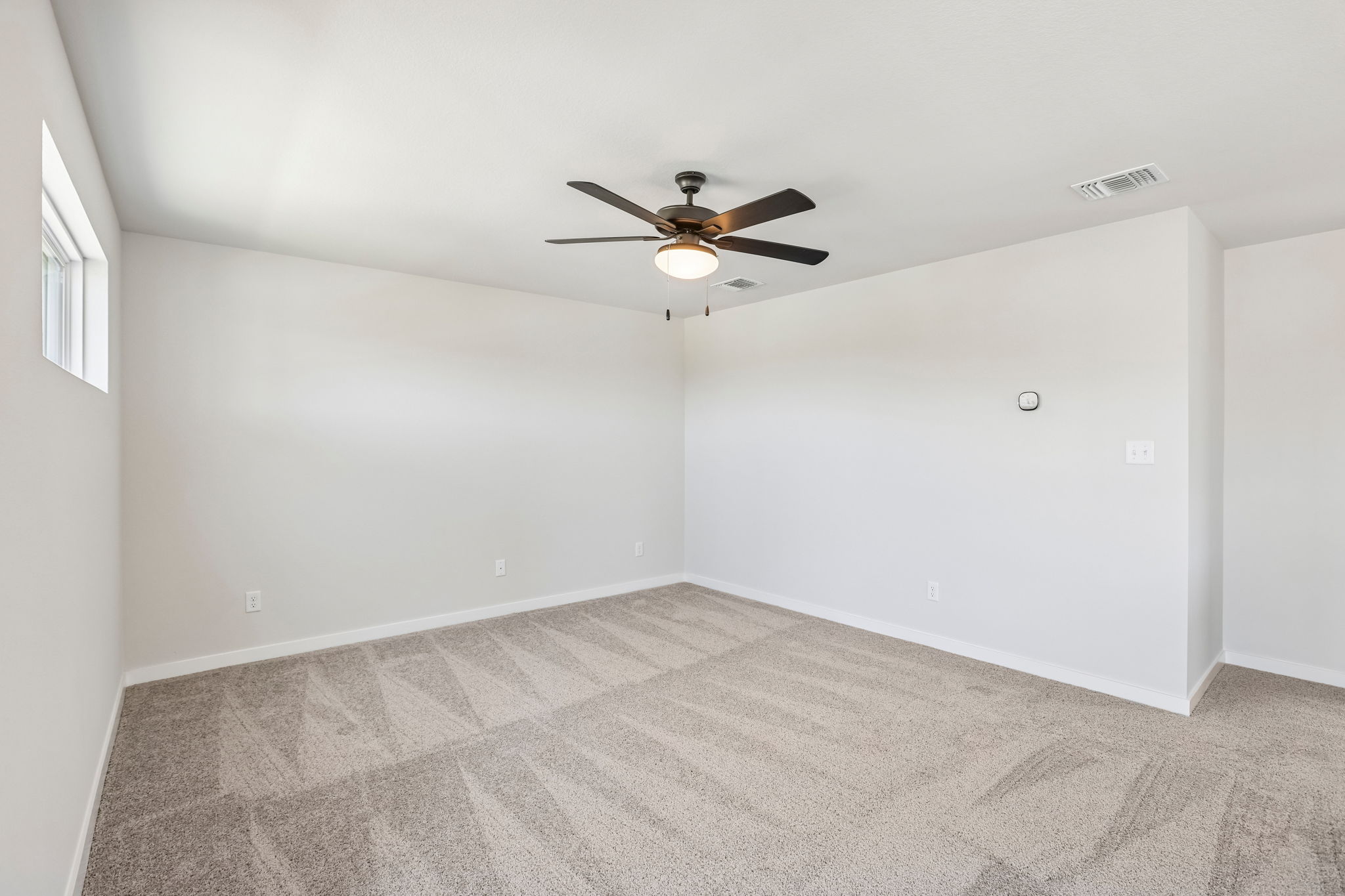 A room with a ceiling fan and a ceiling fan.