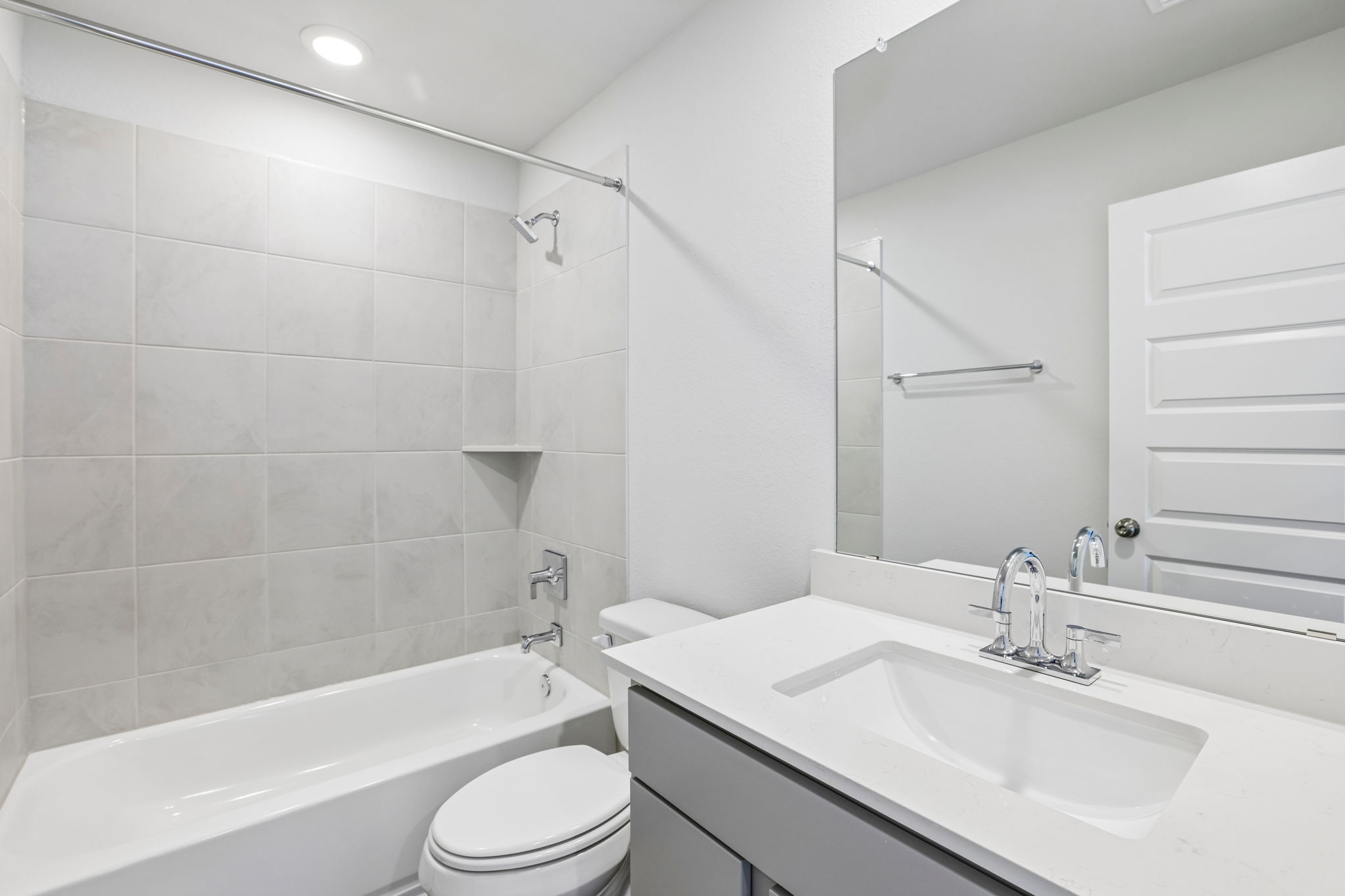 A bathroom with a tub sink and toilet.