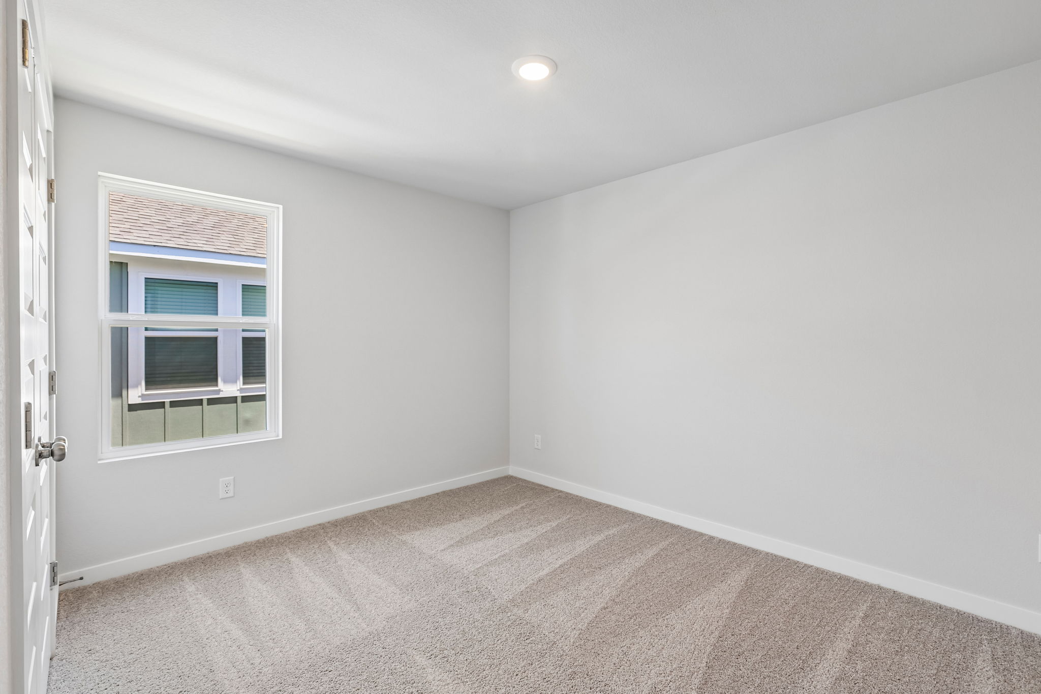 A room with a window and a door.