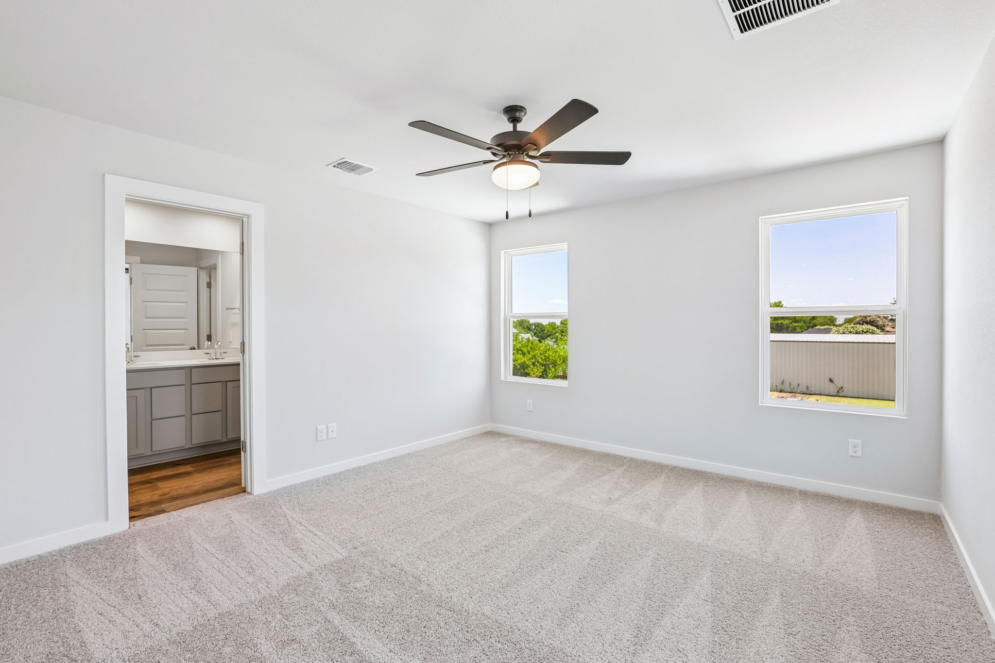 A room with a ceiling fan and a window.